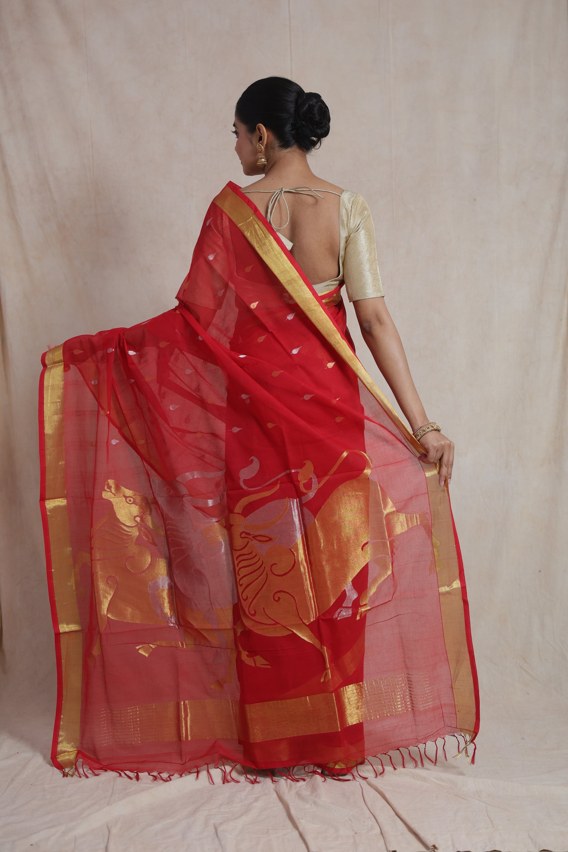 Back view of red Kanchipuram cotton saree with artistic woven pallu