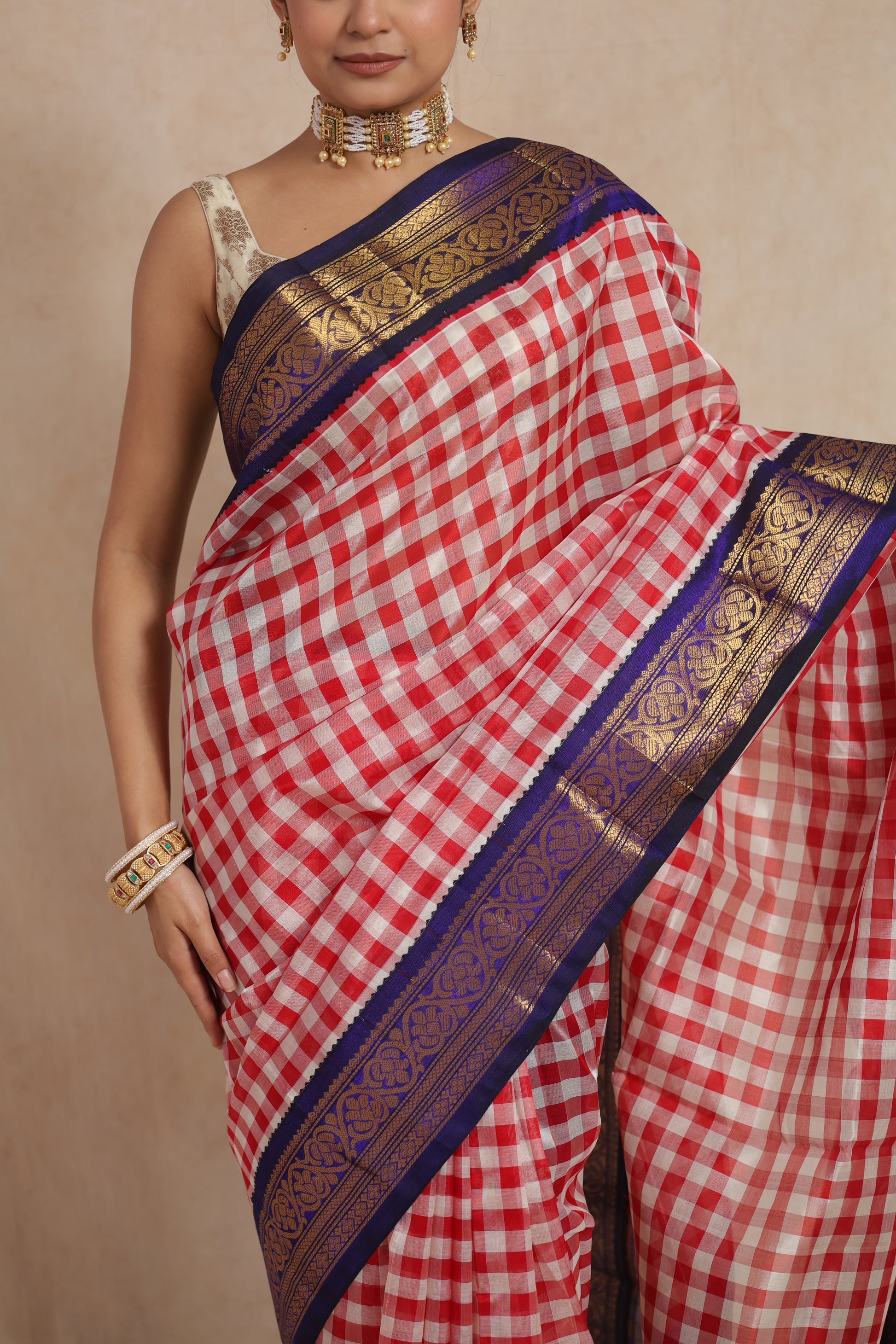 Close-up of red and white checked Kanchipuram Sico saree with blue zari border