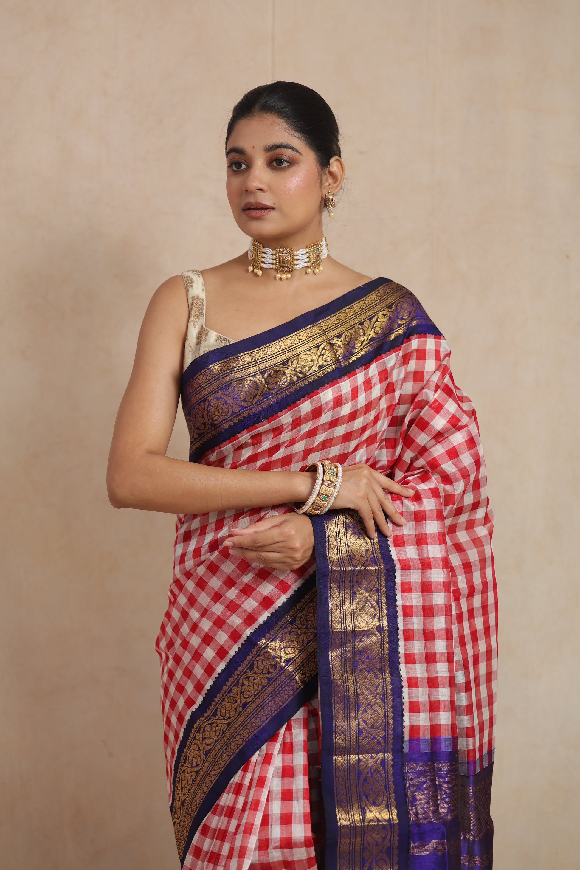 Elegant front look of red and white checked Kanchipuram Sico saree with woven zari border