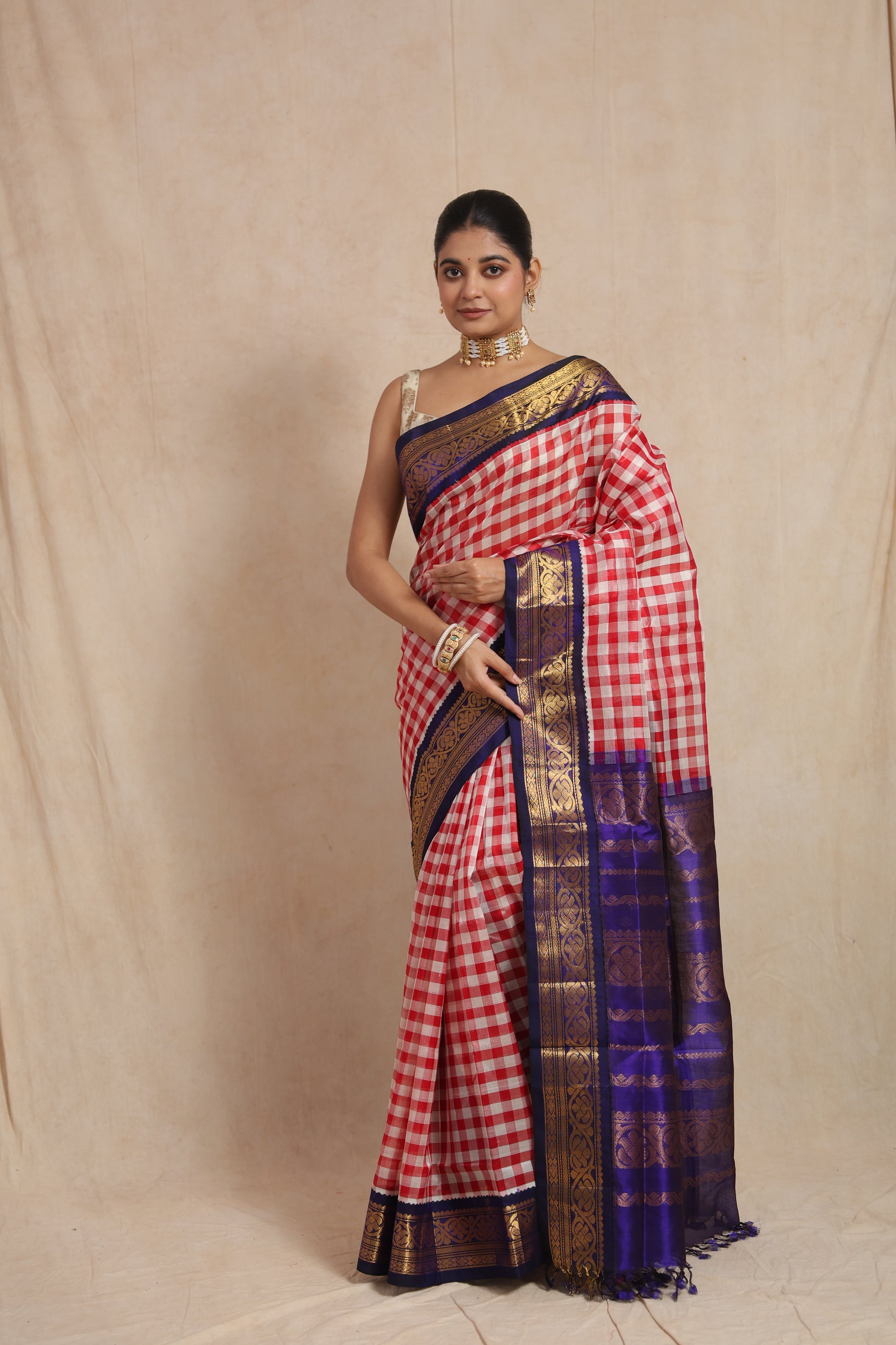 Full drape view of red and white checked Kanchipuram Sico saree with contrast blue border
