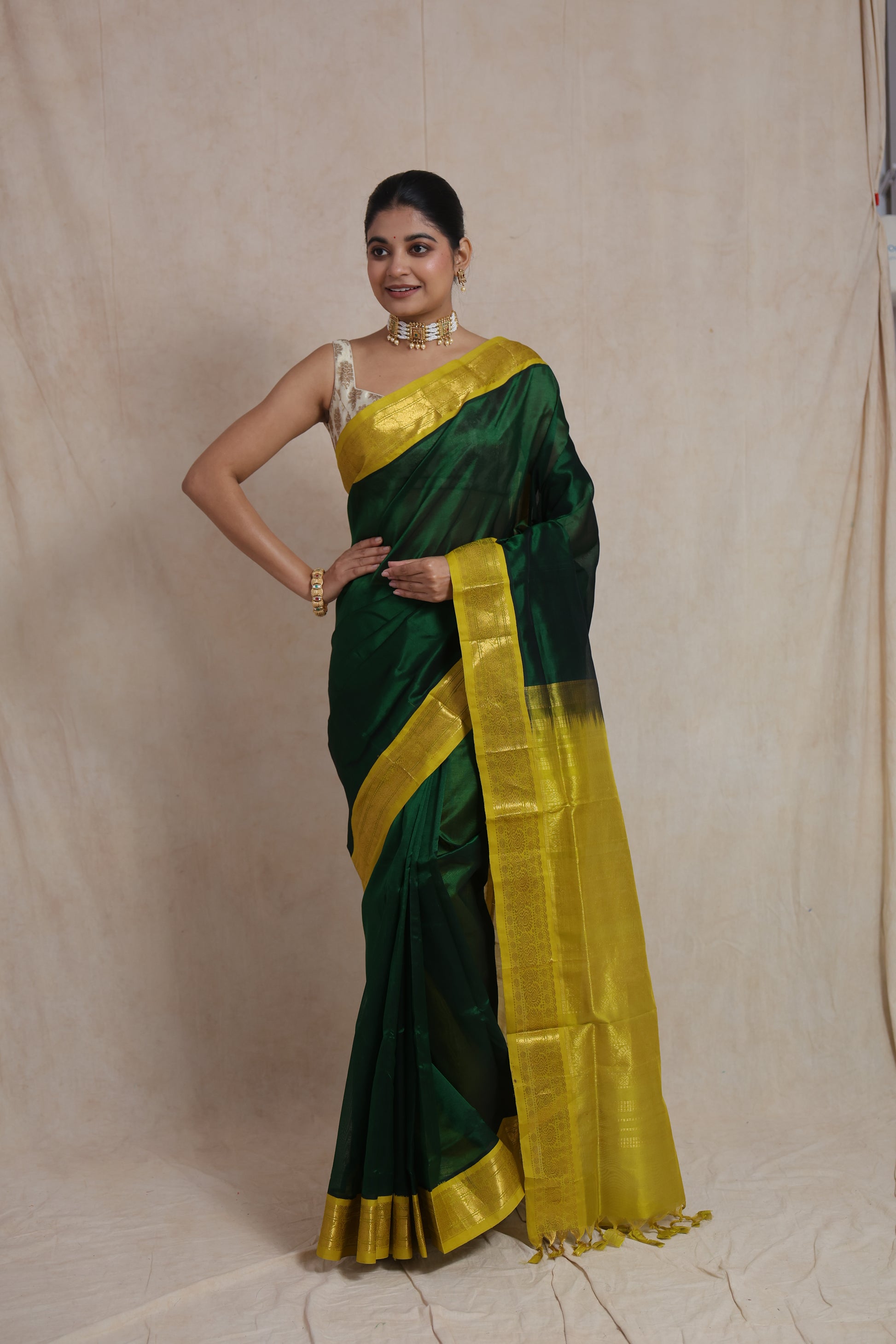 Close-up of mustard zari woven pallu on green silk cotton saree