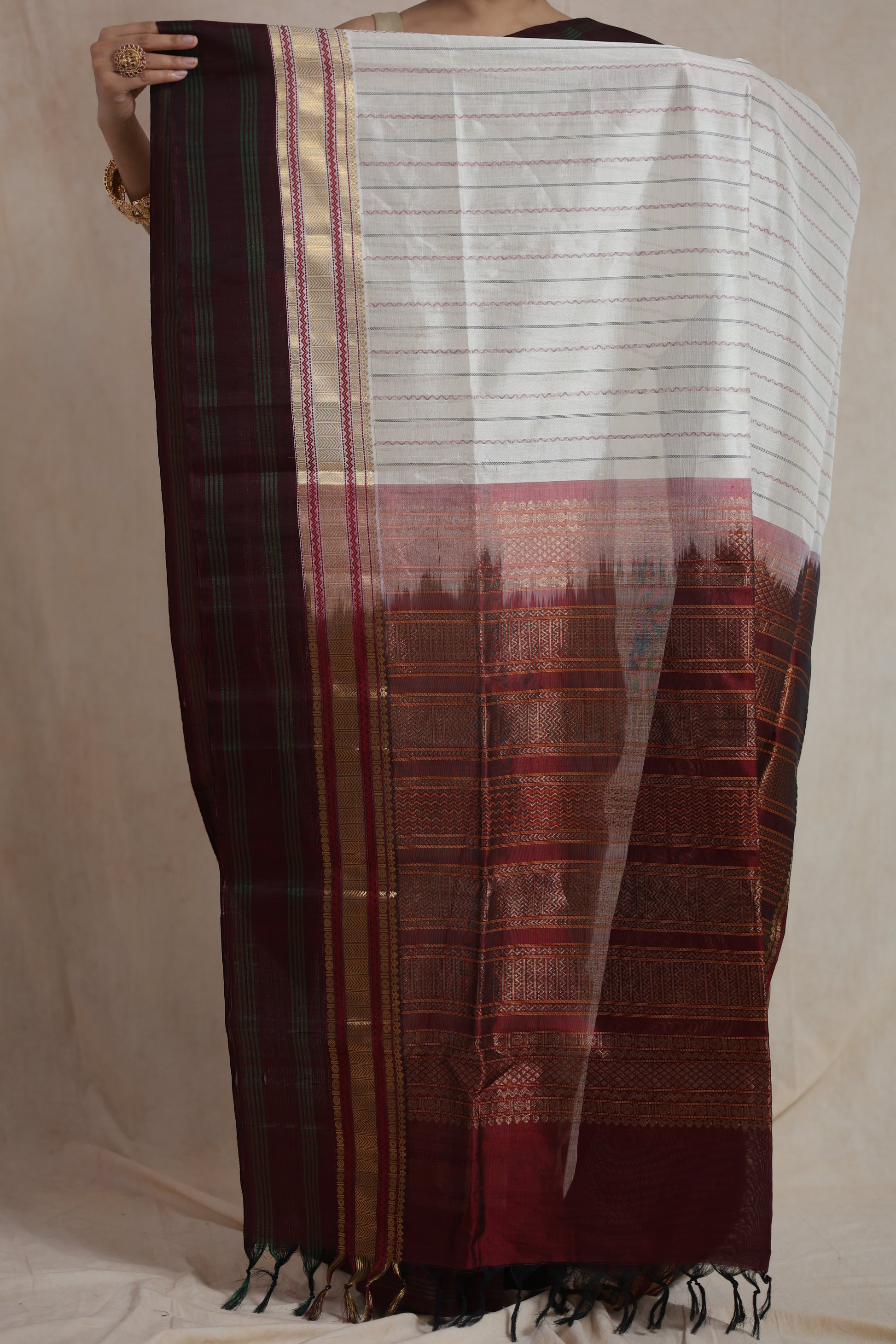Traditional zari woven pallu on maroon bordered Kanchipuram saree