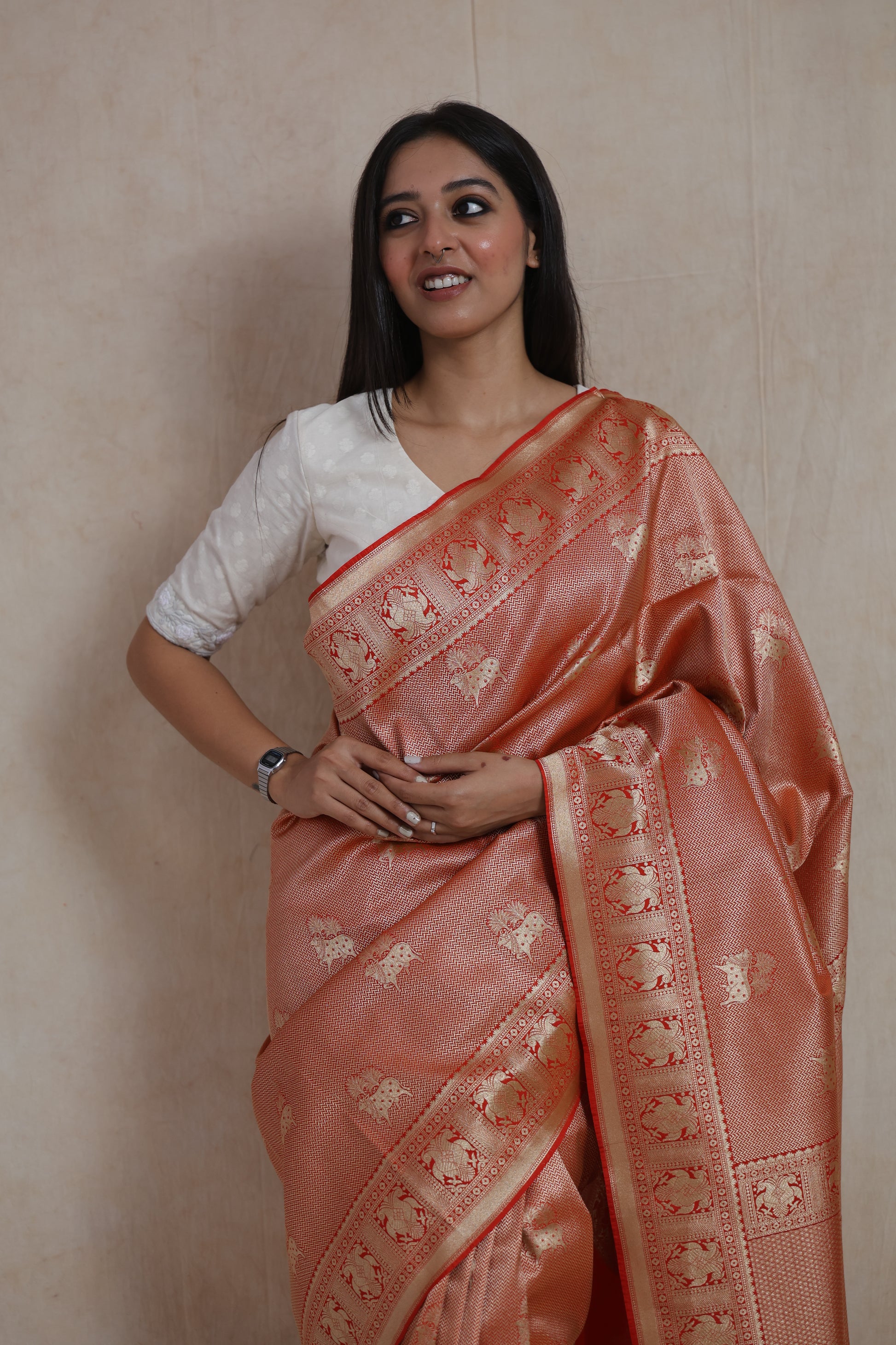 Close-up of rose gold Banarasi silk saree with traditional elephant motif weaving and rich contrast accents