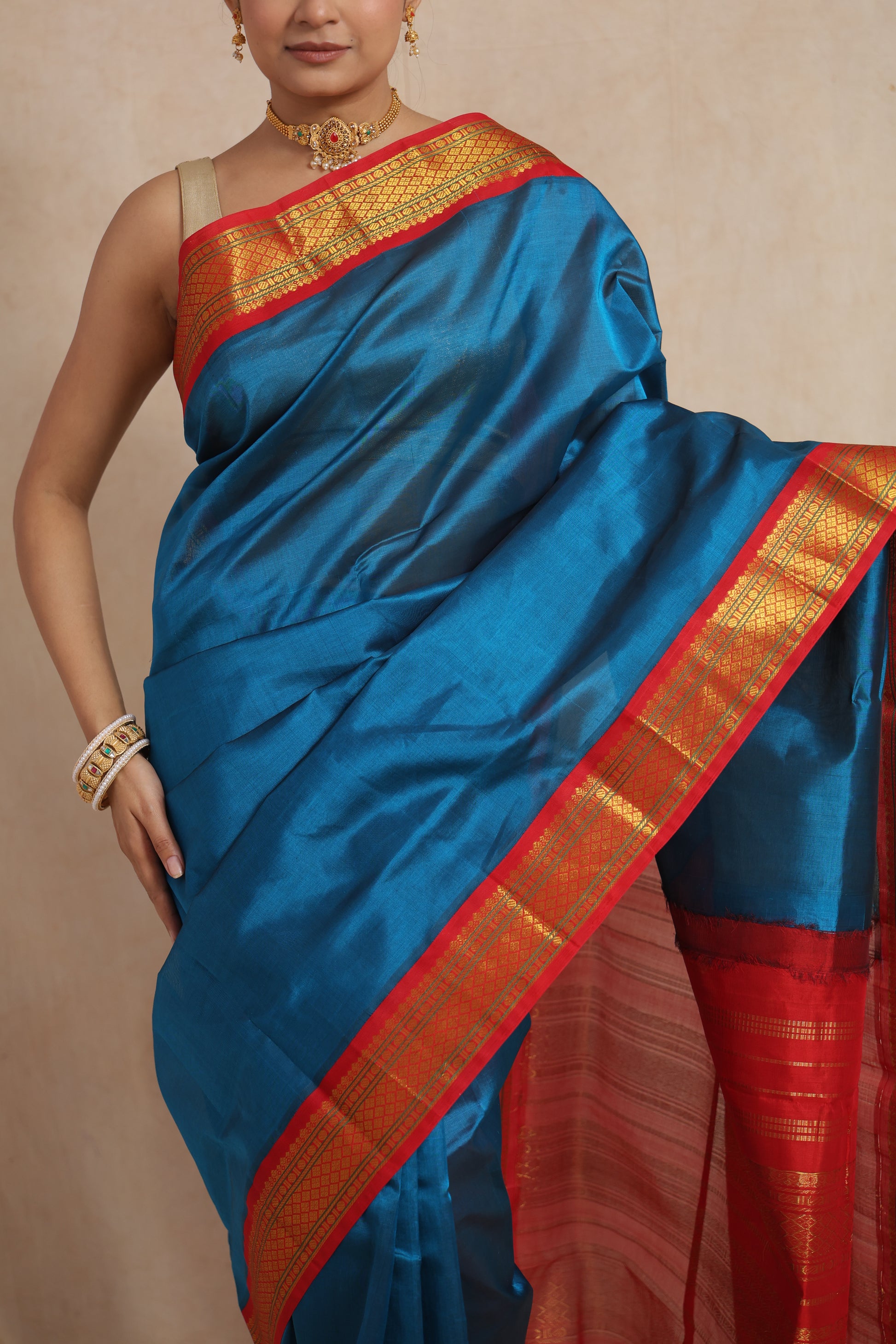 Crimson red zari woven border detail of royal blue Kanchipuram Sico saree
