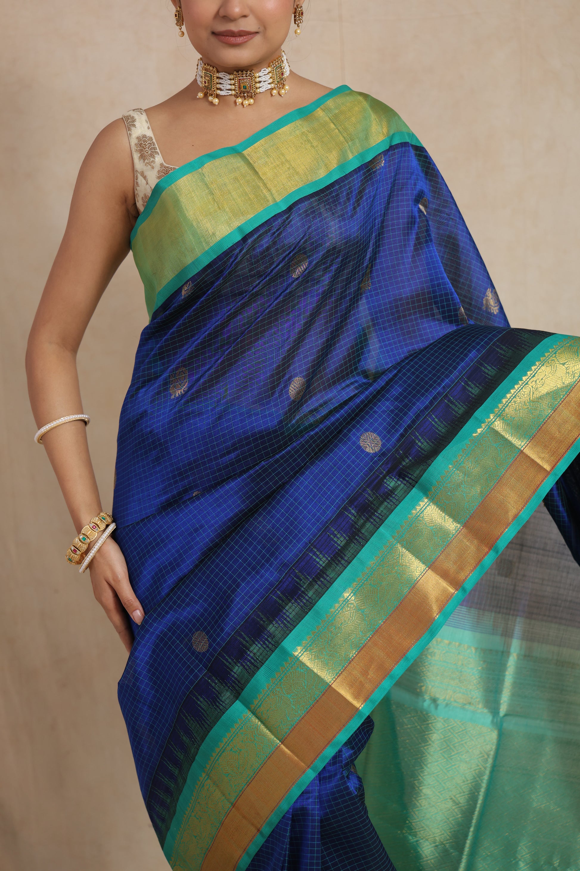 Close-up of royal blue Kanchipuram Sico saree with aqua green zari border