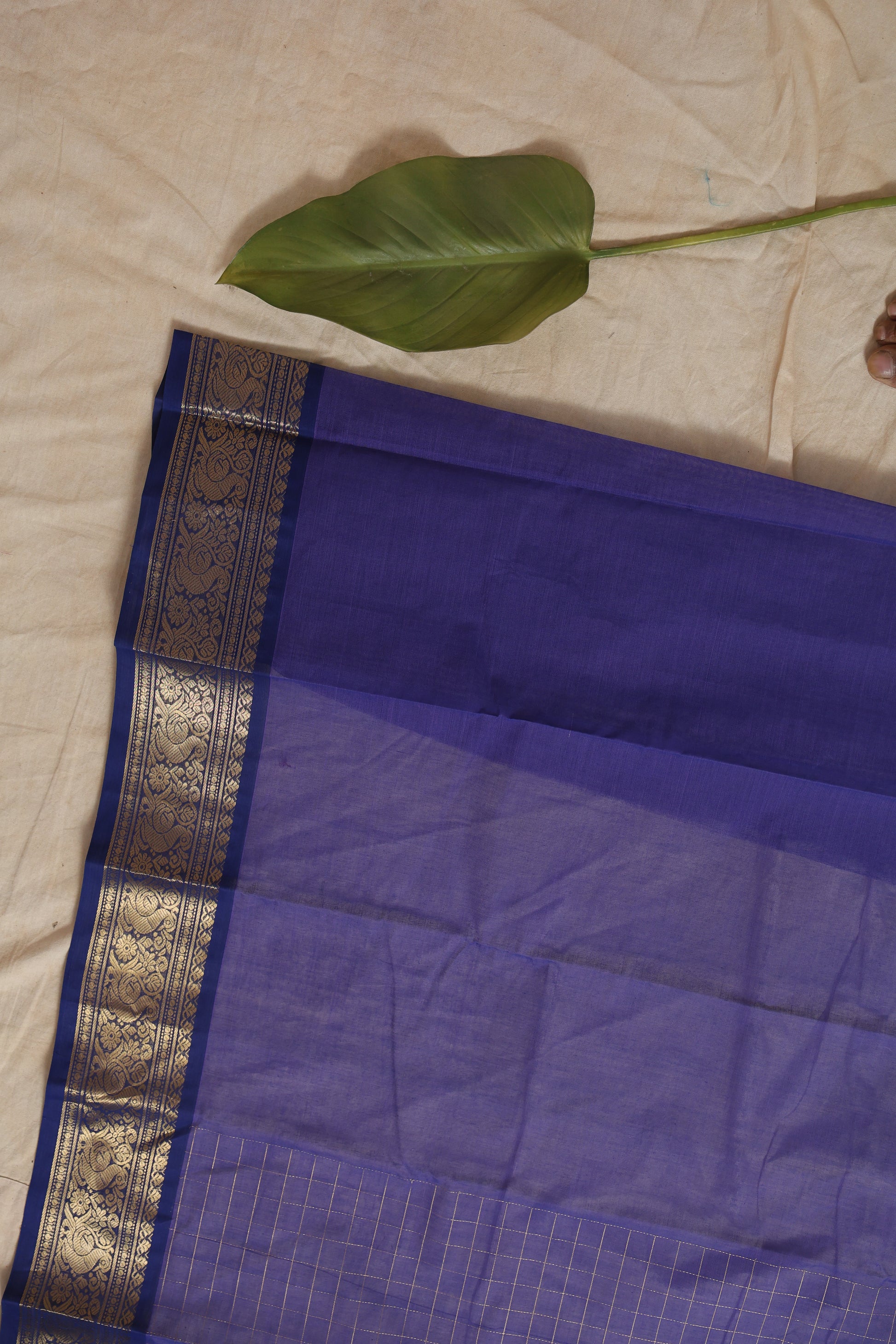 Folded royal blue Kanchipuram cotton saree with woven border