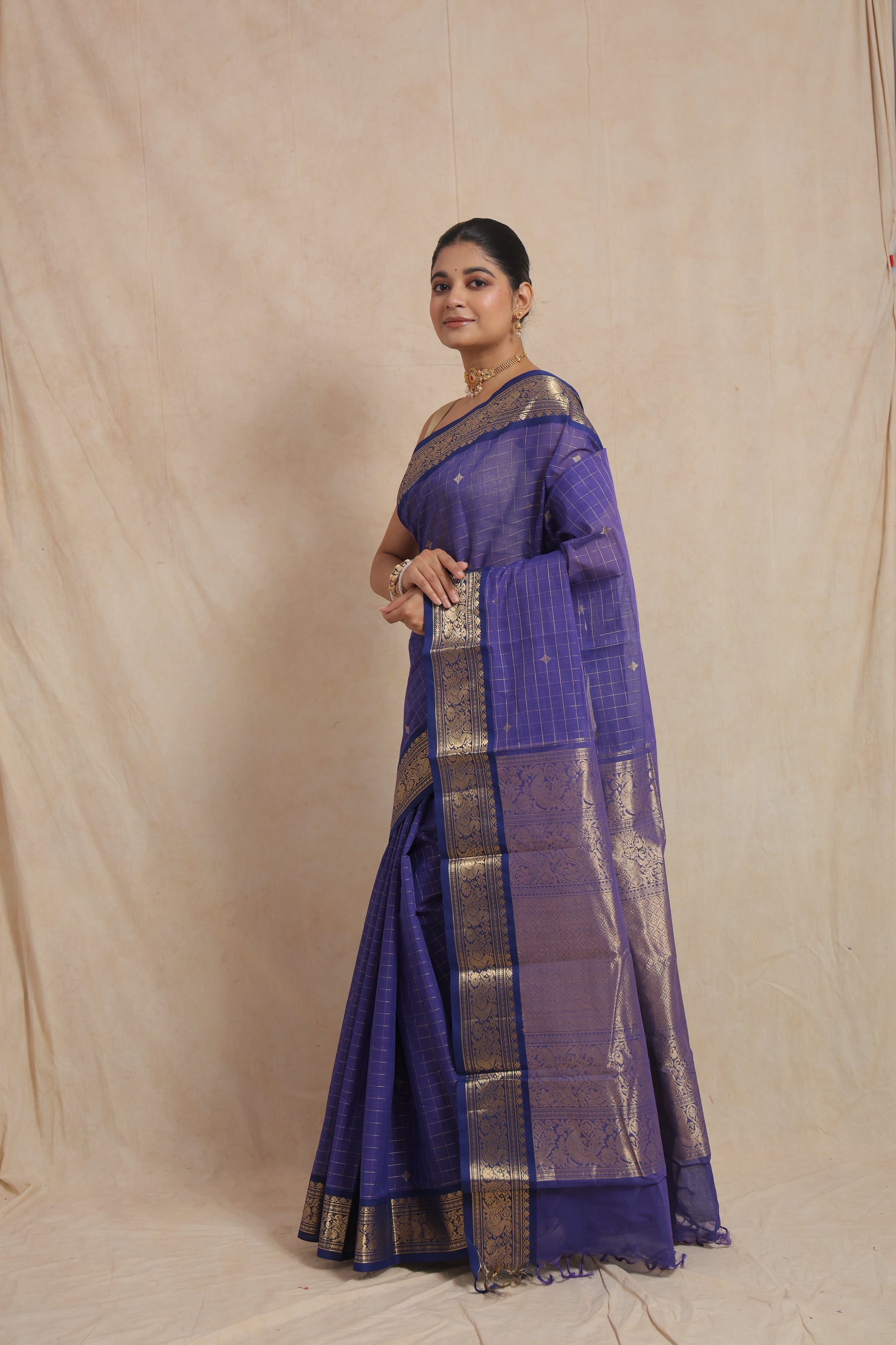 Side profile of royal blue Kanchipuram cotton saree on model