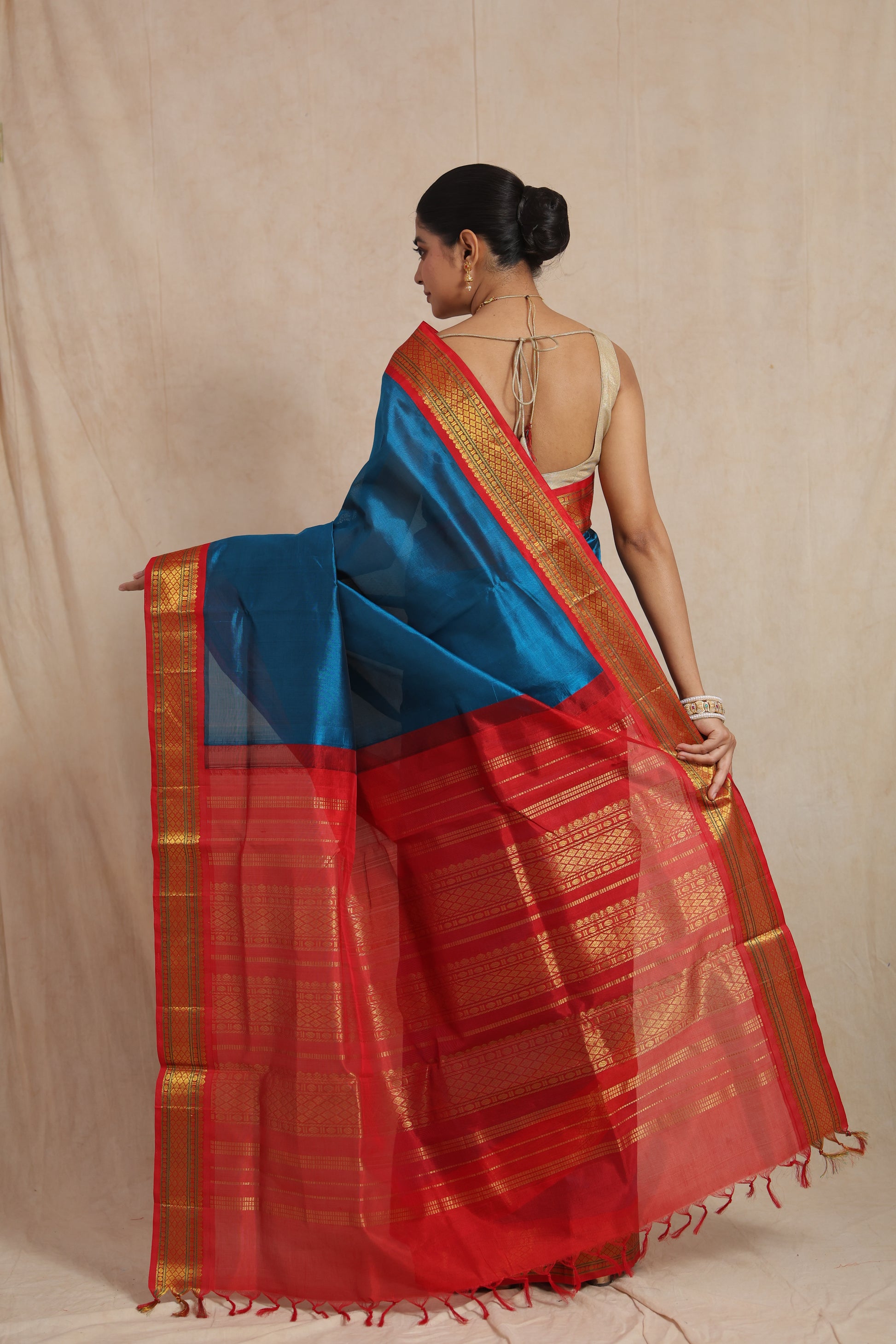 Back drape view of royal blue Kanchipuram Sico saree with rich red pallu