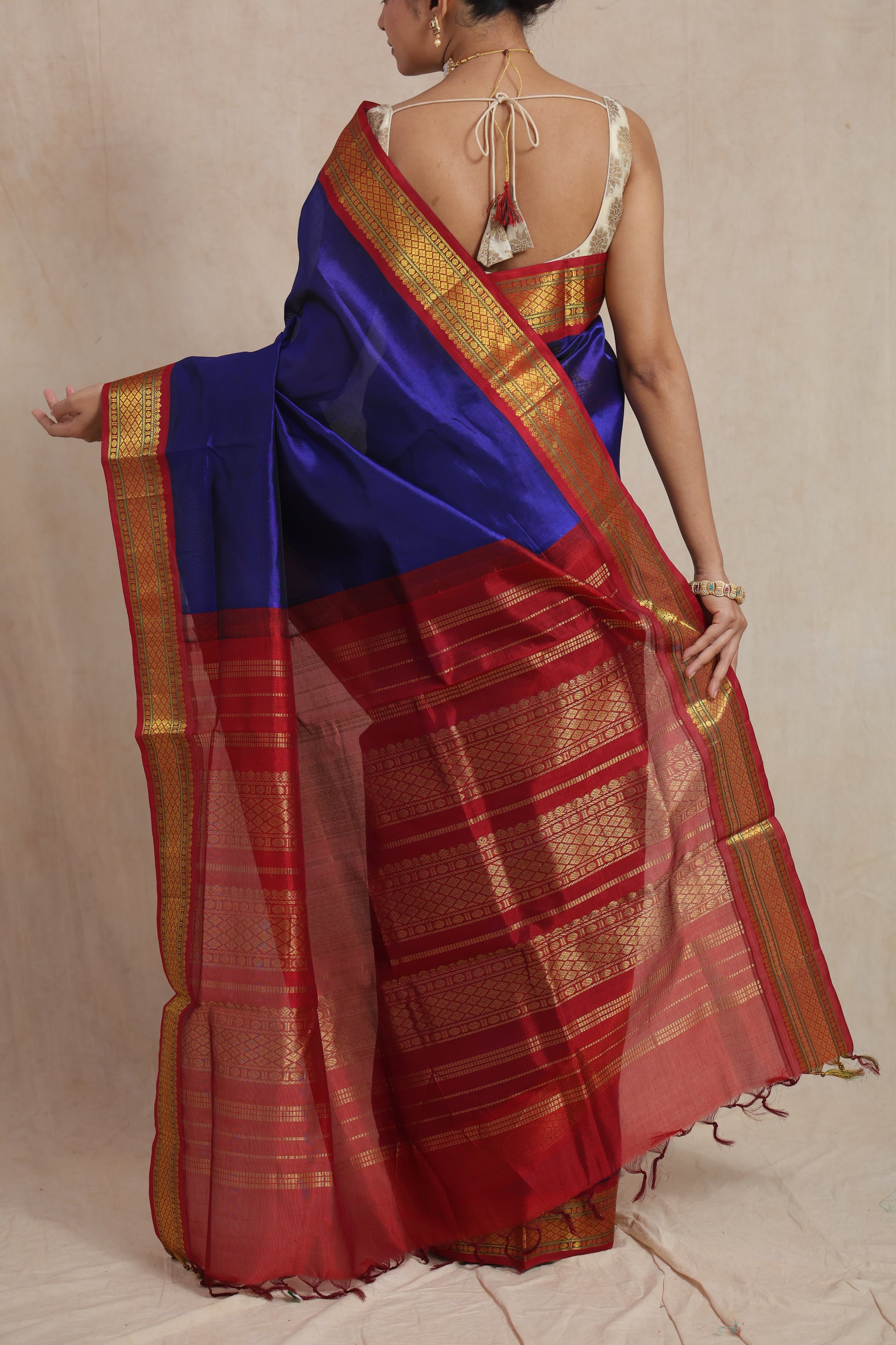 Back drape view of royal blue Kanchipuram Sico saree with crimson red zari pallu