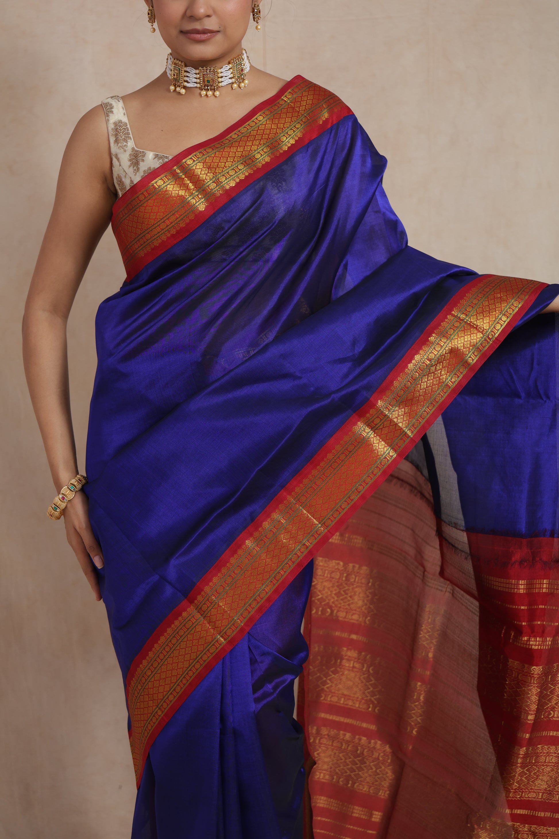 Close-up of royal blue Kanchipuram Sico saree featuring crimson red zari woven border