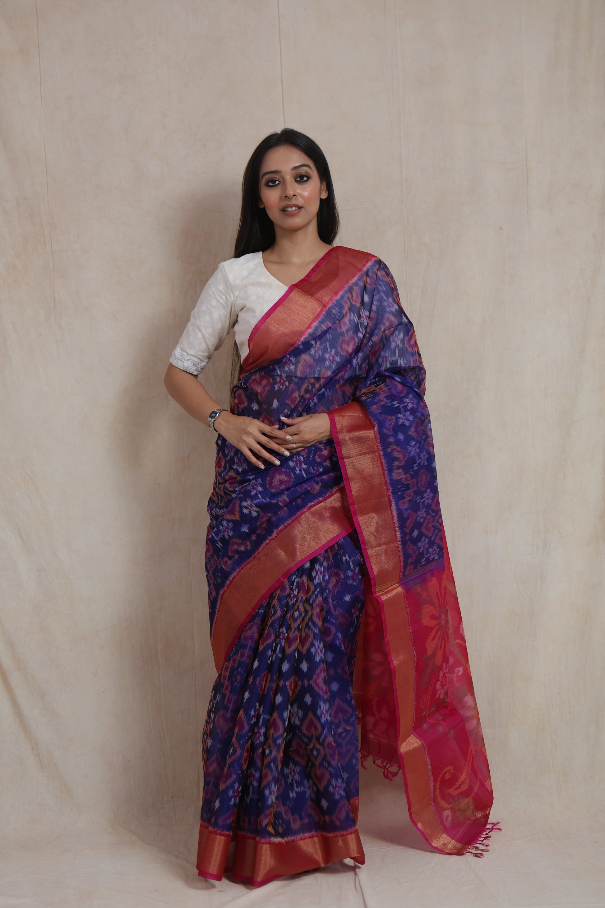 Front view of royal indigo Pochampally handloom silk cotton saree with traditional Ikat motifs and pink floral pallu