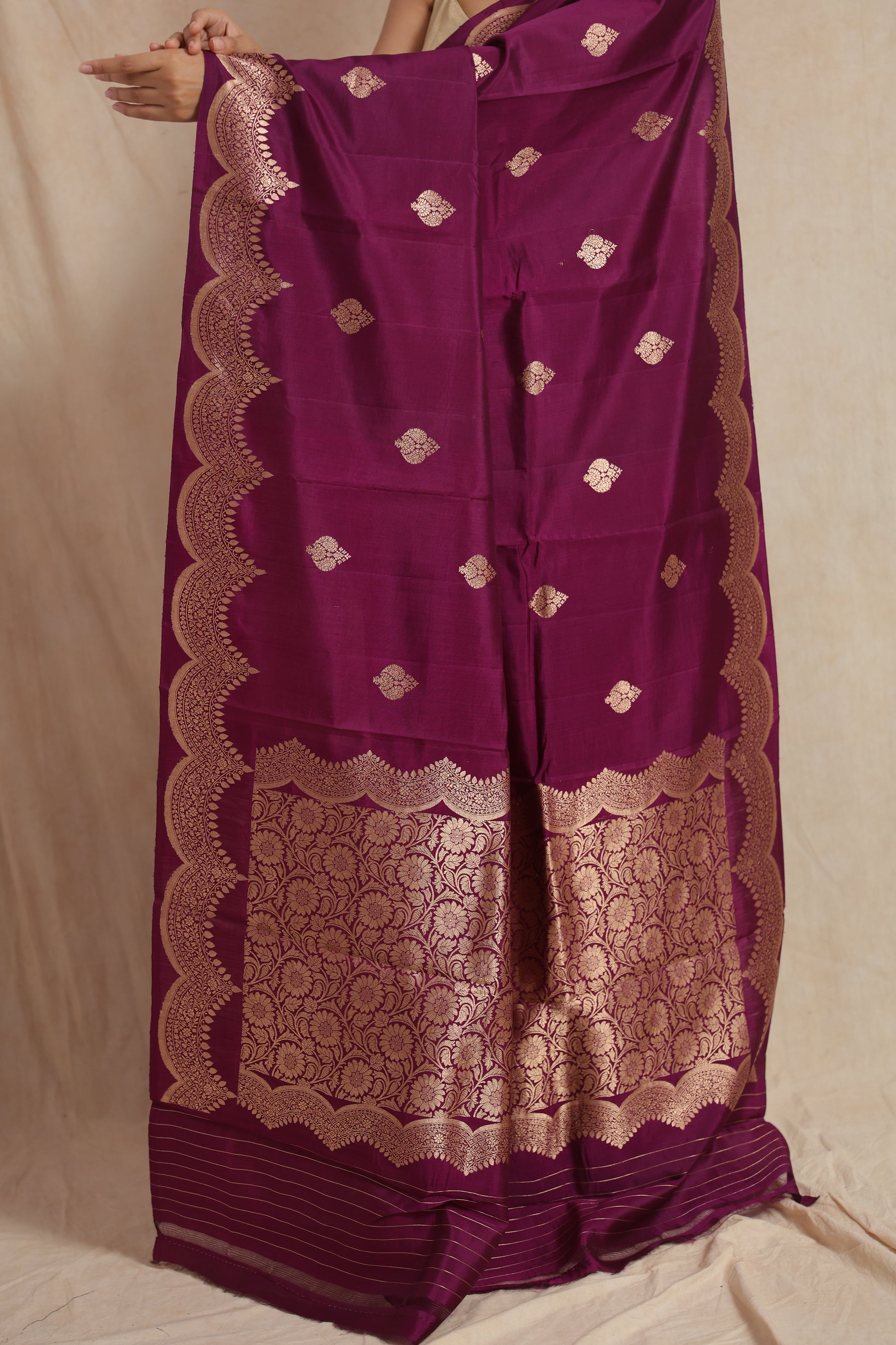 Elegant drape of royal magenta Banarasi art silk saree featuring woven buttas and decorative border