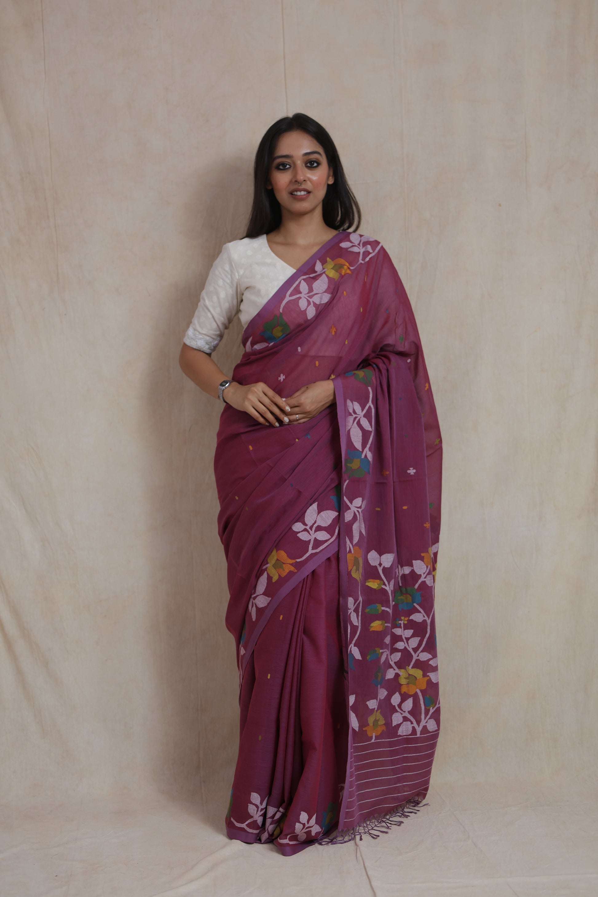 Front view of royal plum Bengal Cotton Fulia saree with multicolor floral woven border