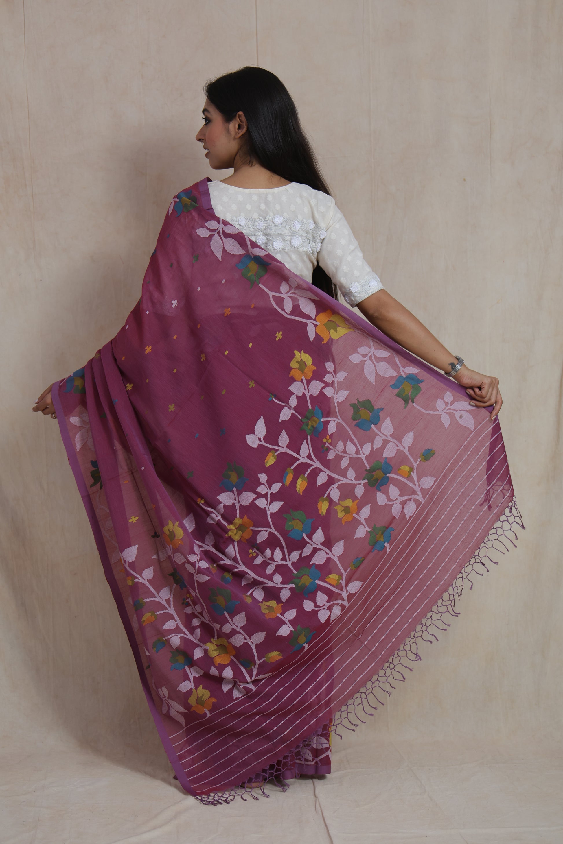 Detailed pallu view of Bengal Cotton Fulia saree with multicolor floral vine weaving and tassels