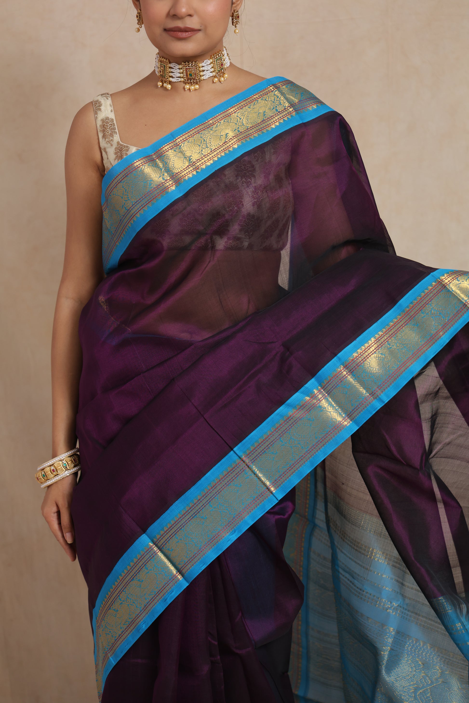 Close-up of royal purple Kanchipuram Sico saree with sky blue zari woven border