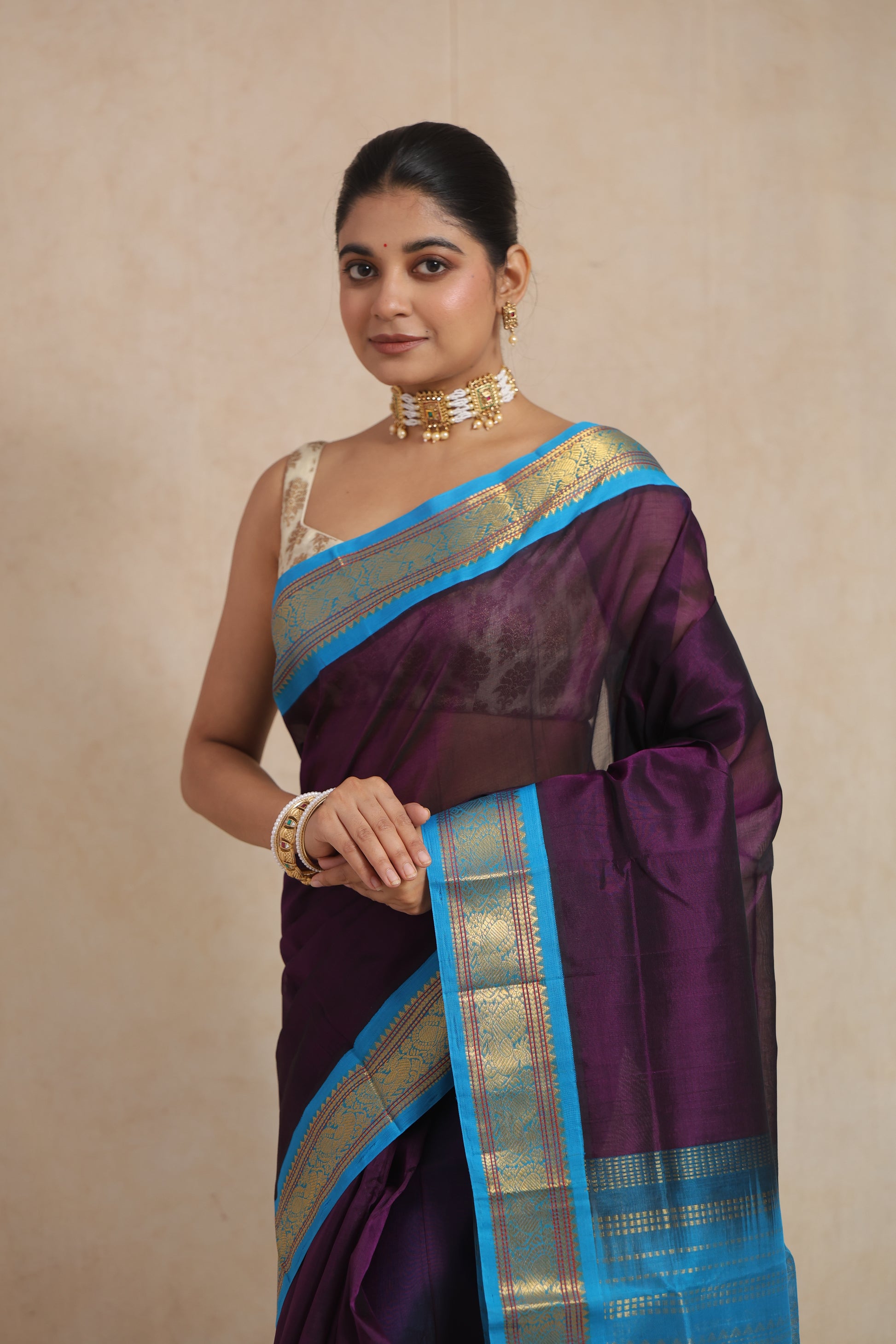 Front portrait of royal purple Kanchipuram Sico saree with blue zari border and pallu