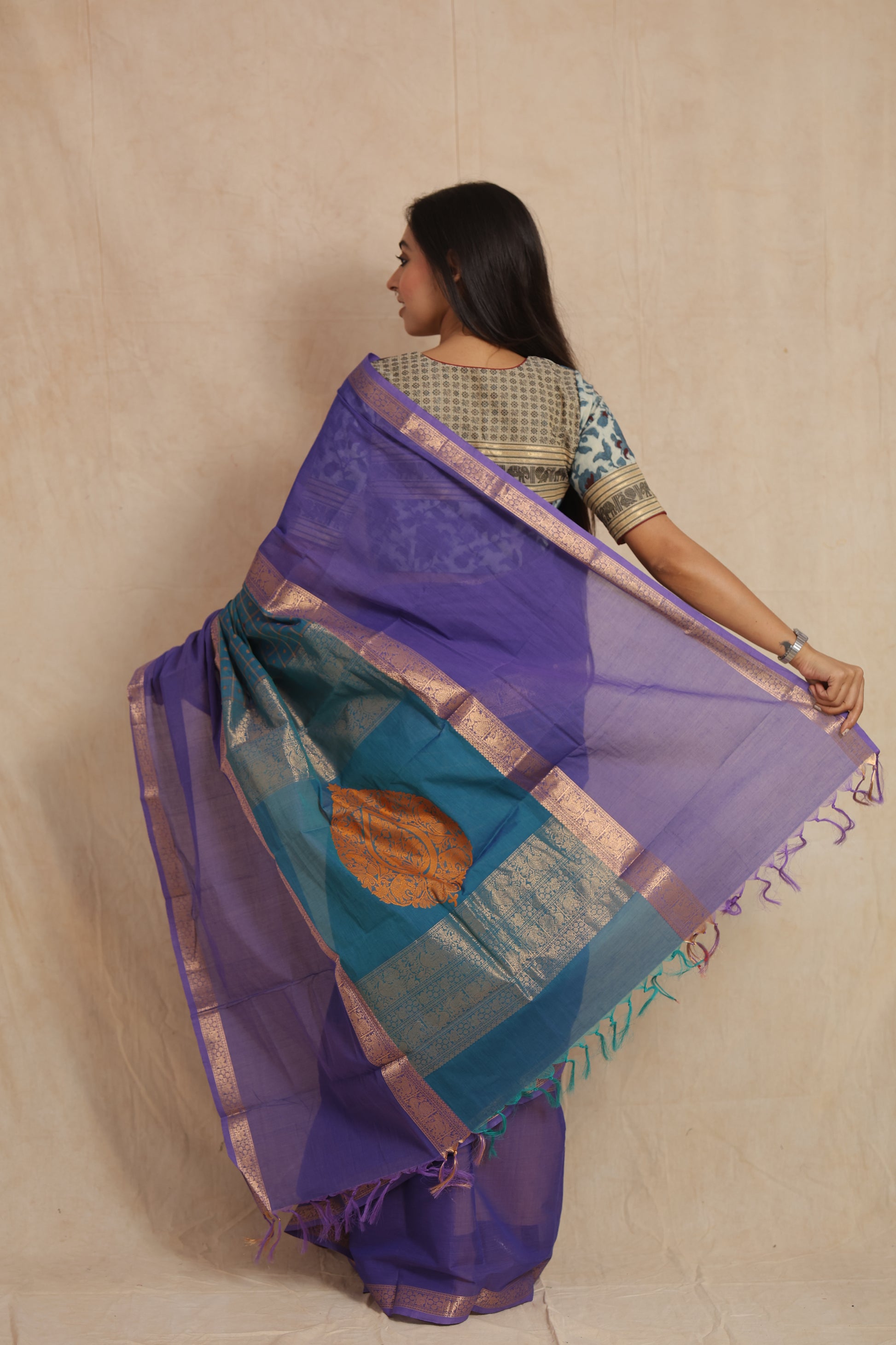 Back drape view of royal purple Kanchipuram cotton saree with teal woven pallu