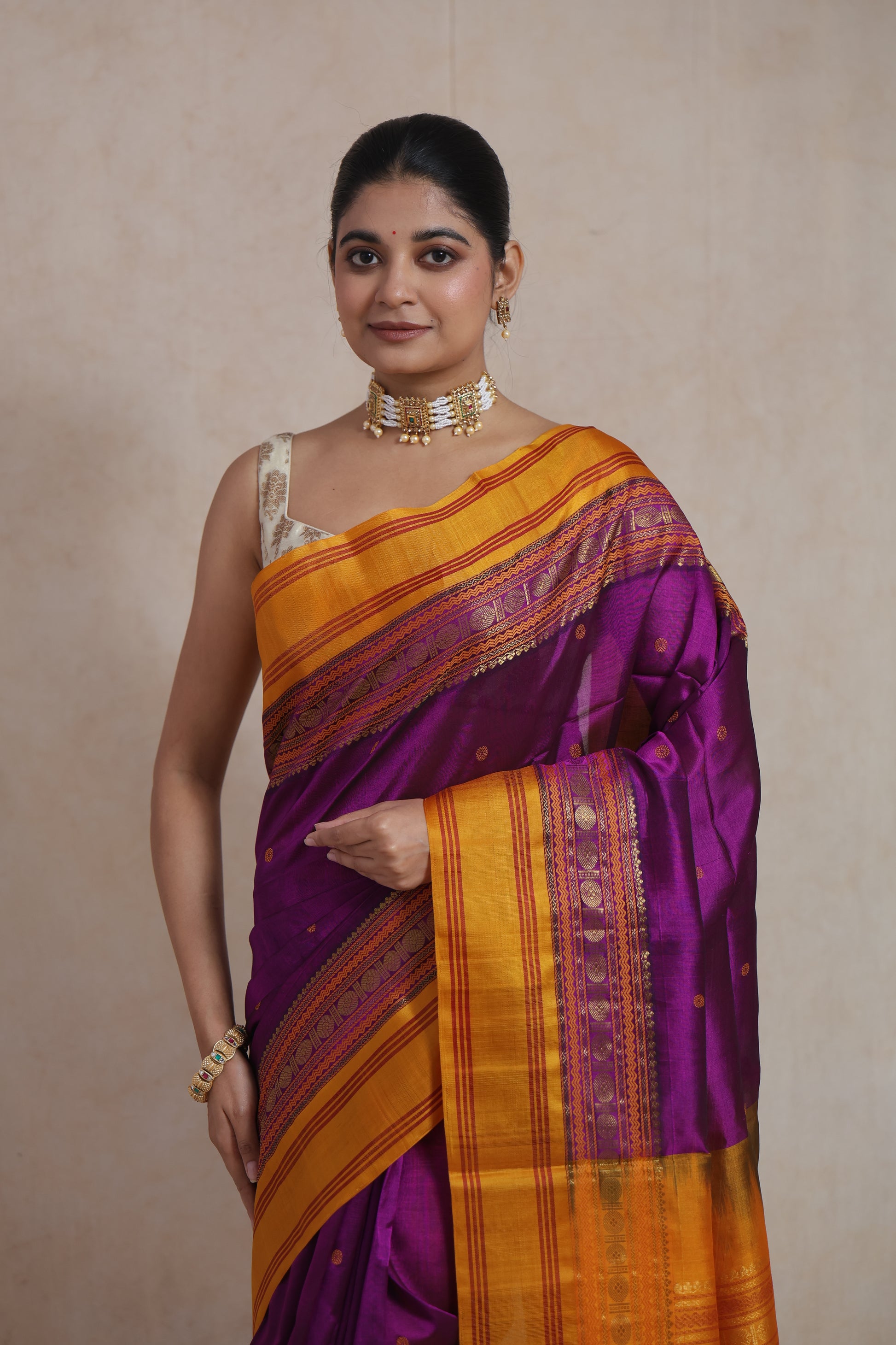 Close-up of royal purple Kanchipuram Sico saree with mustard gold zari border