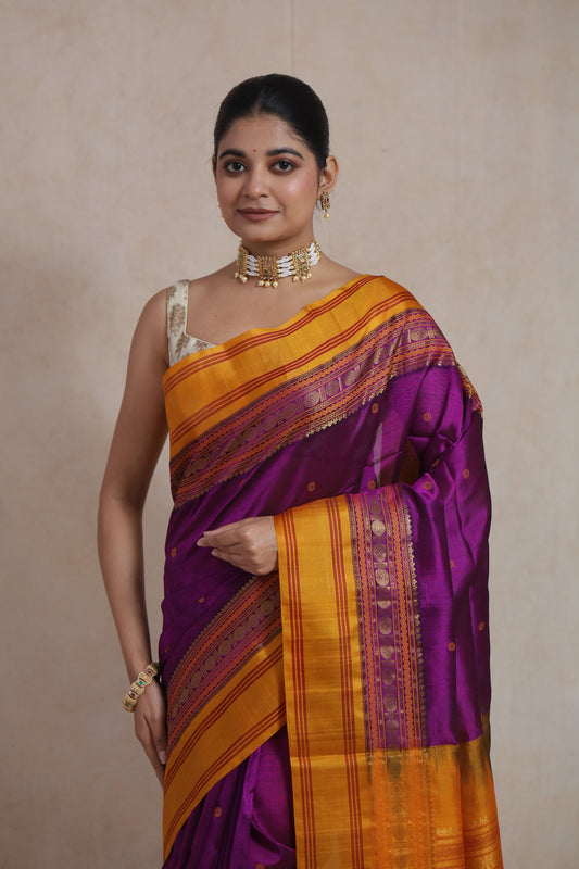 Close-up of royal purple Kanchipuram Sico saree with mustard gold zari border