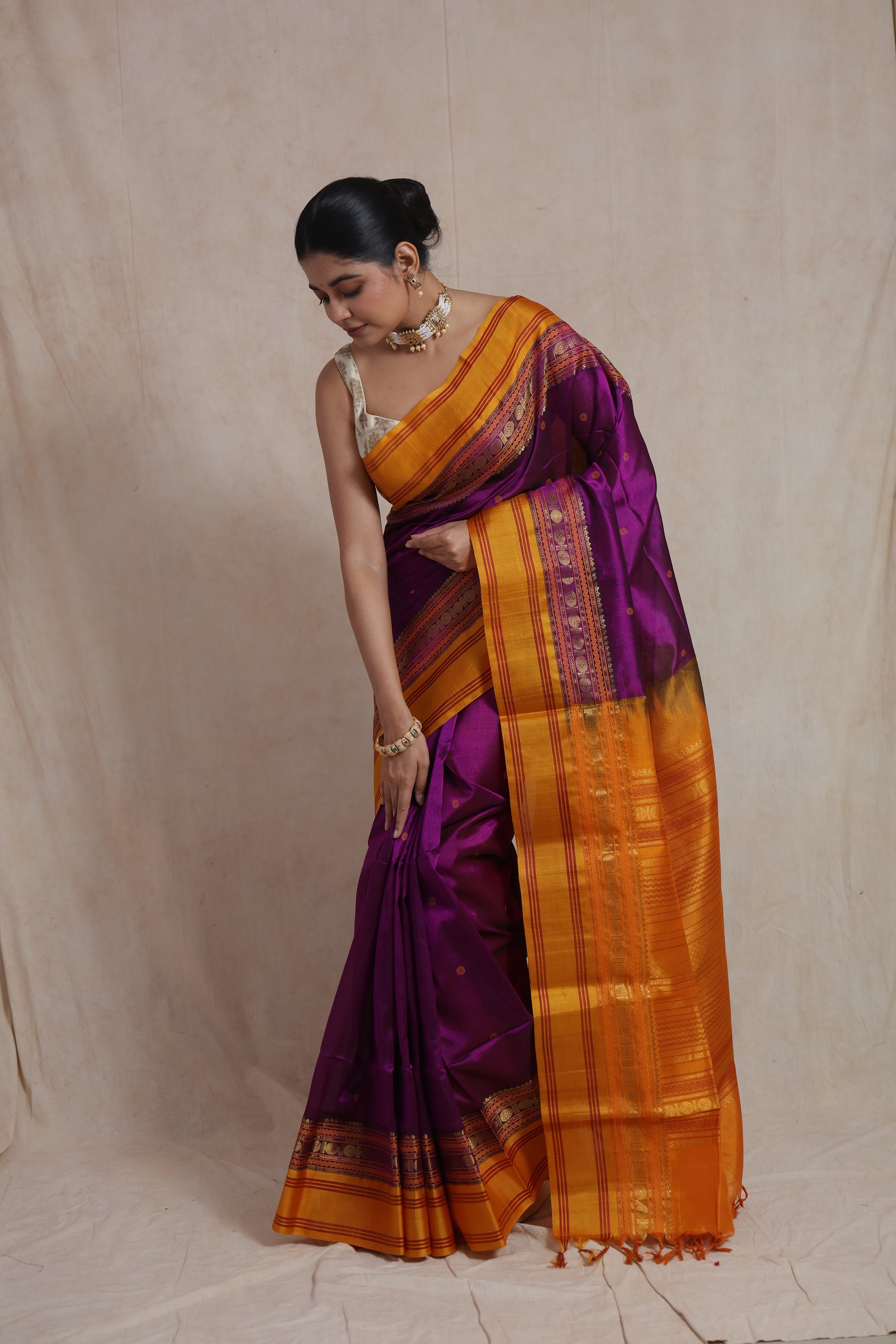 Elegant drape of royal purple Kanchipuram Sico saree with zari buttas