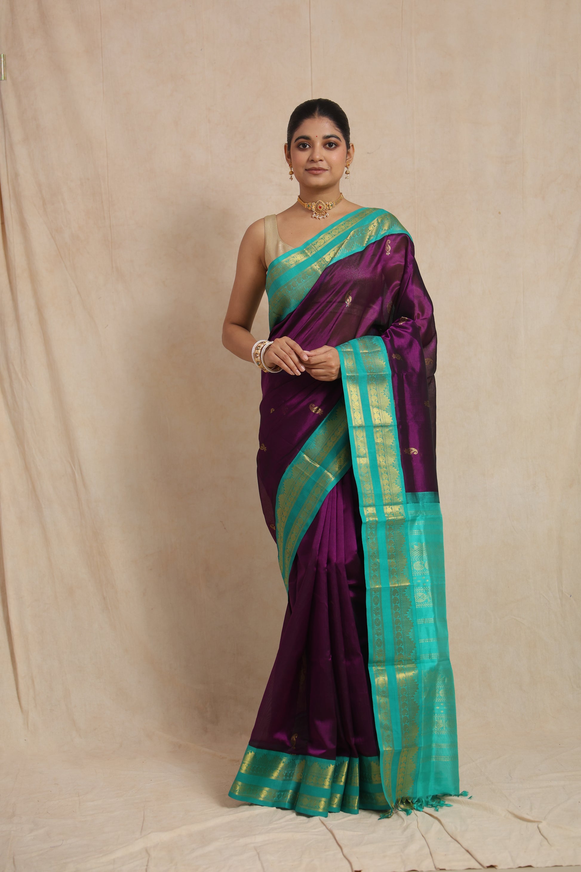 Elegant front drape of royal purple Kanchipuram Sico saree with contrast aqua border