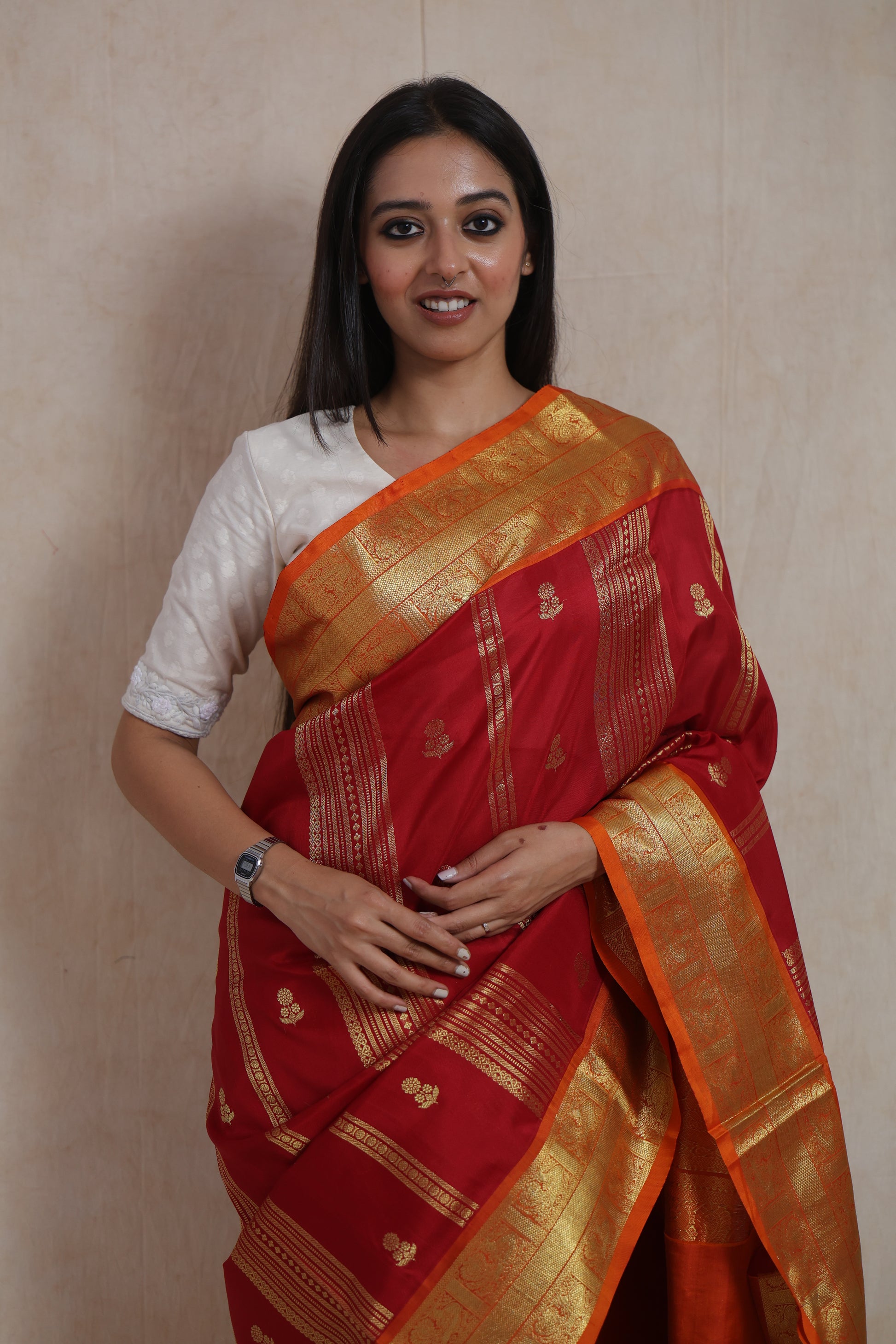 Front view of royal crimson Venkatgiri handloom silk saree with orange woven border