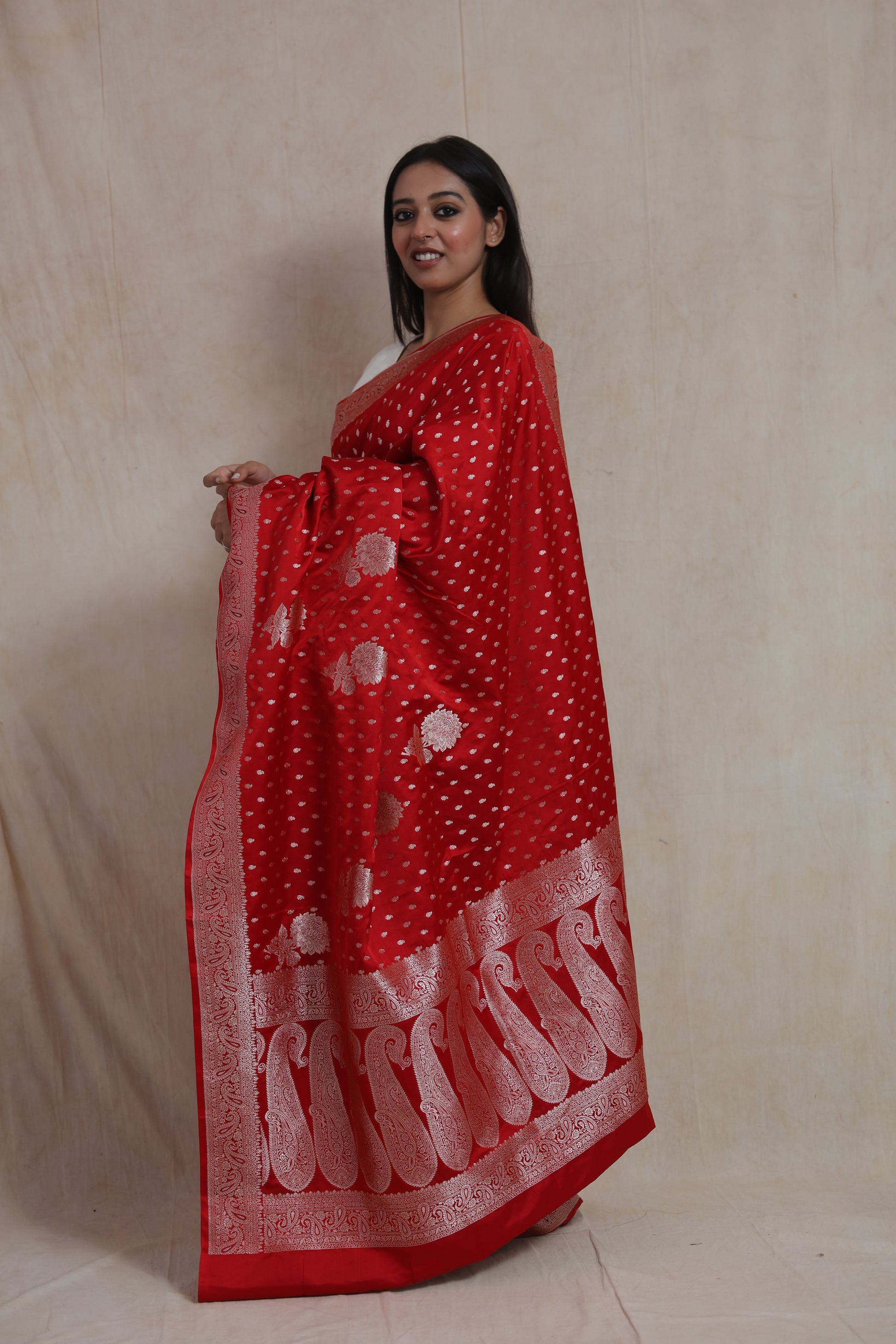 Side profile of red Banarasi art silk saree featuring silver woven motifs and traditional pallu