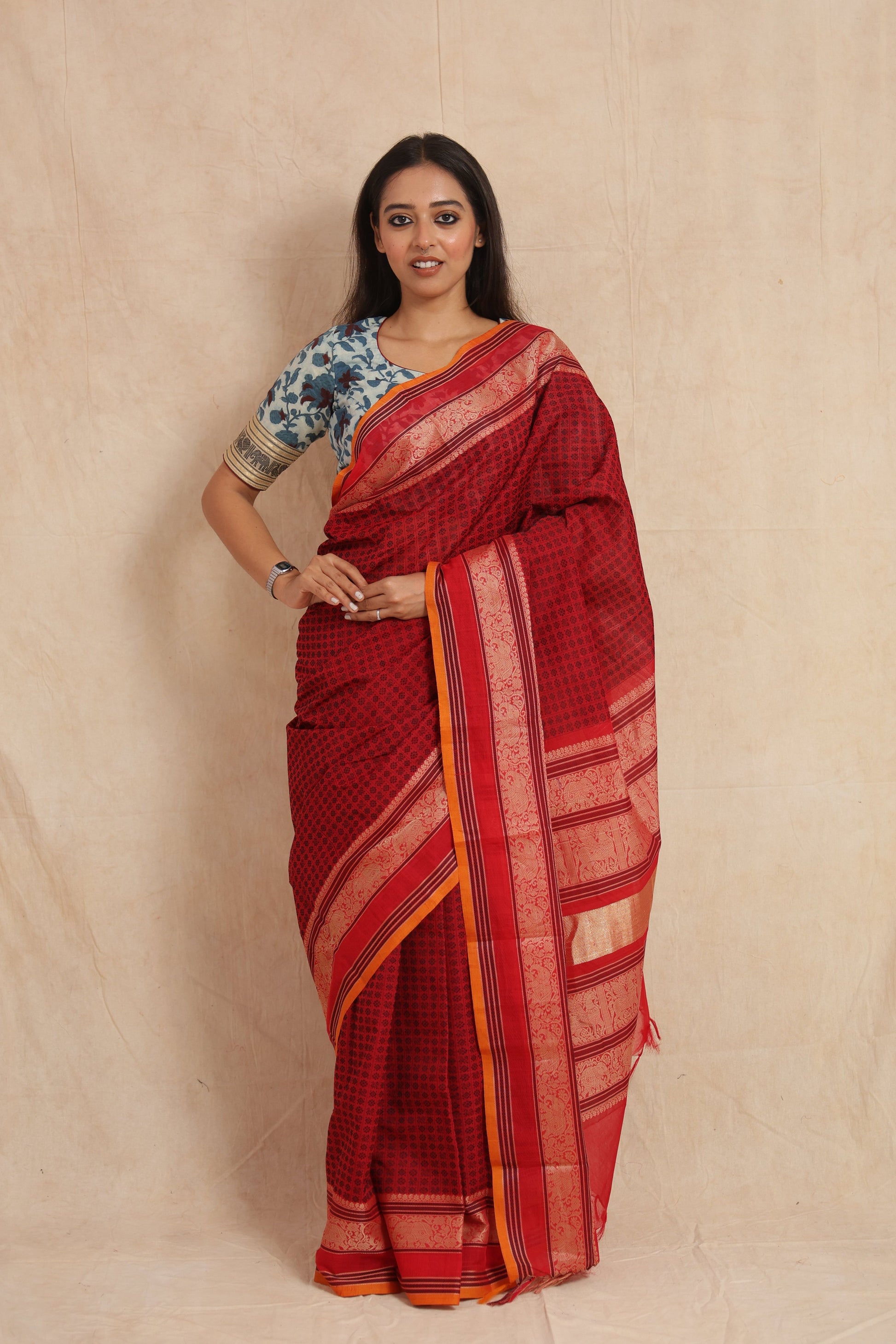 Full view of ruby red Kanchipuram cotton saree with detailed woven pallu