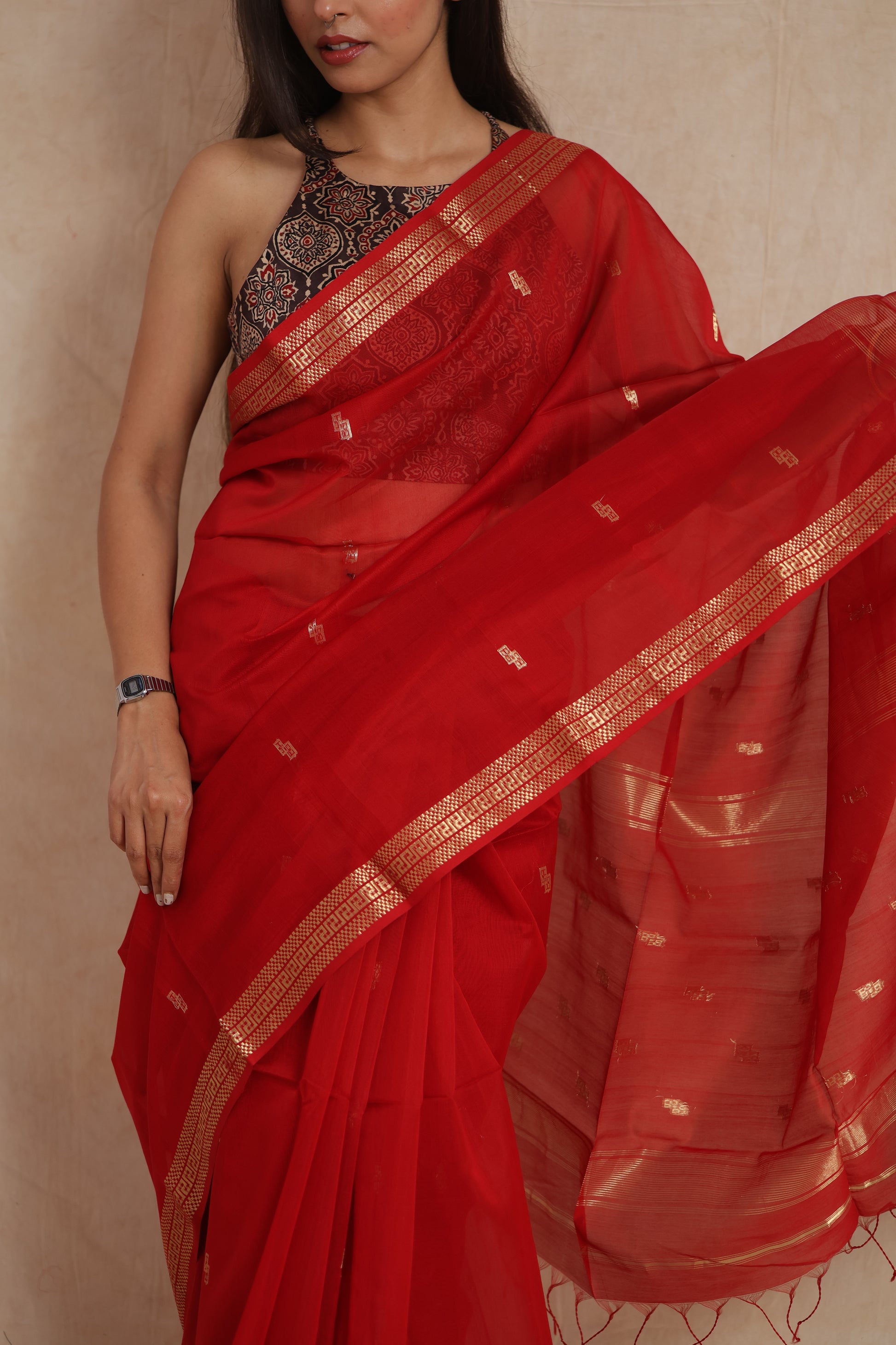 Elegant pose in ruby red Maheshwari Sico saree with delicate woven motifs