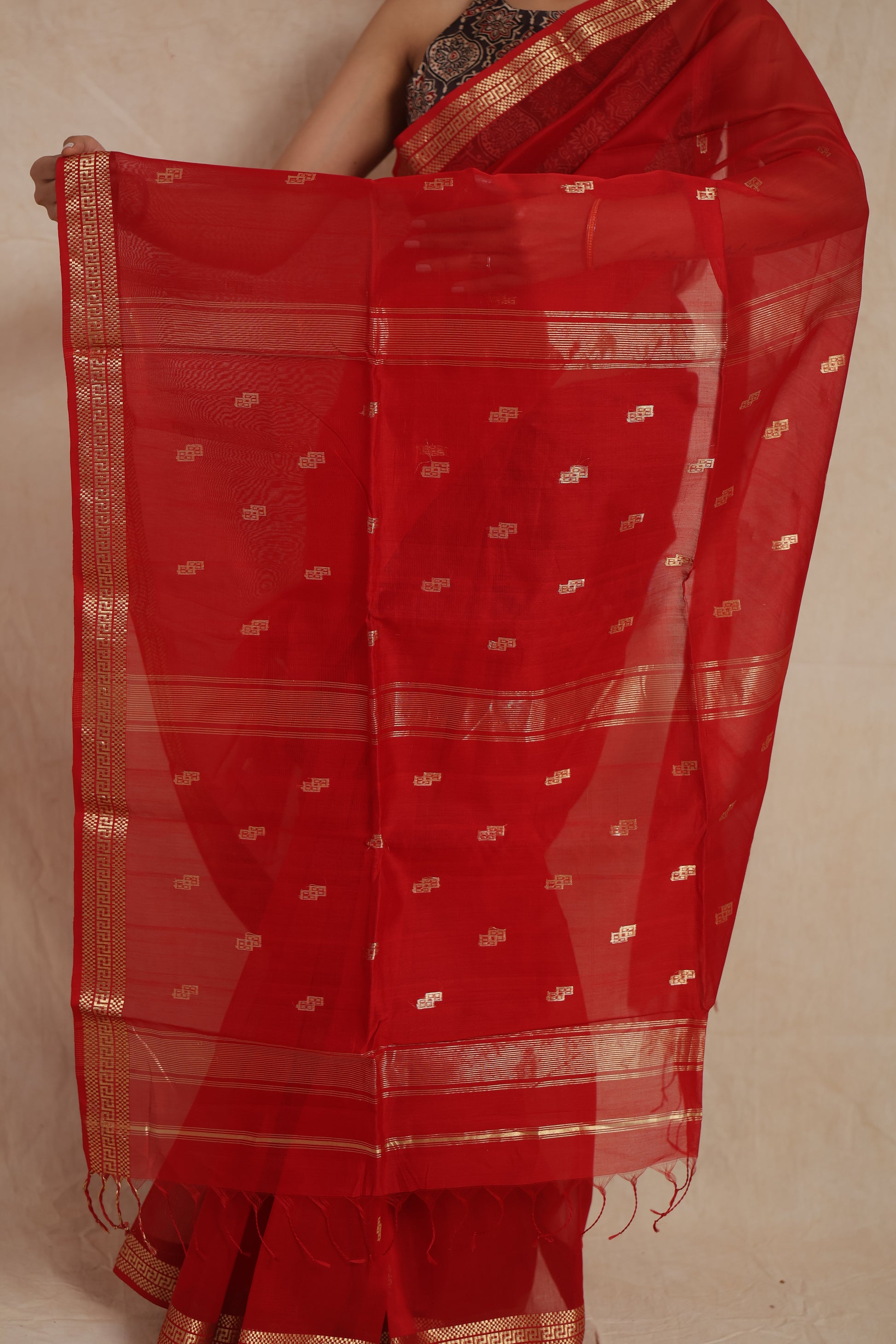 Close-up of sheer ruby red Maheshwari Sico pallu with woven motifs