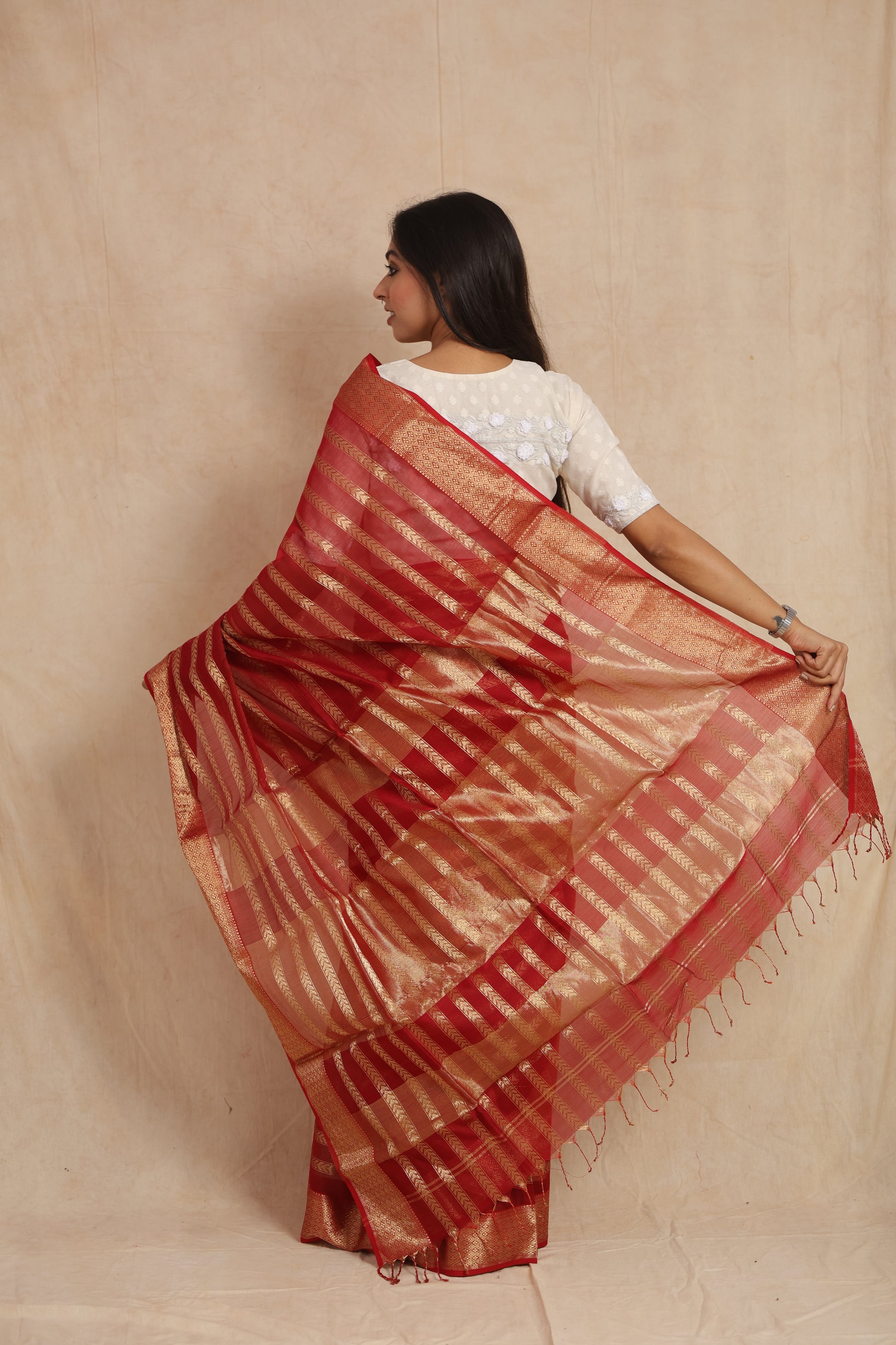 Back view of ruby red Maheshwari silk tissue saree with gold woven stripes