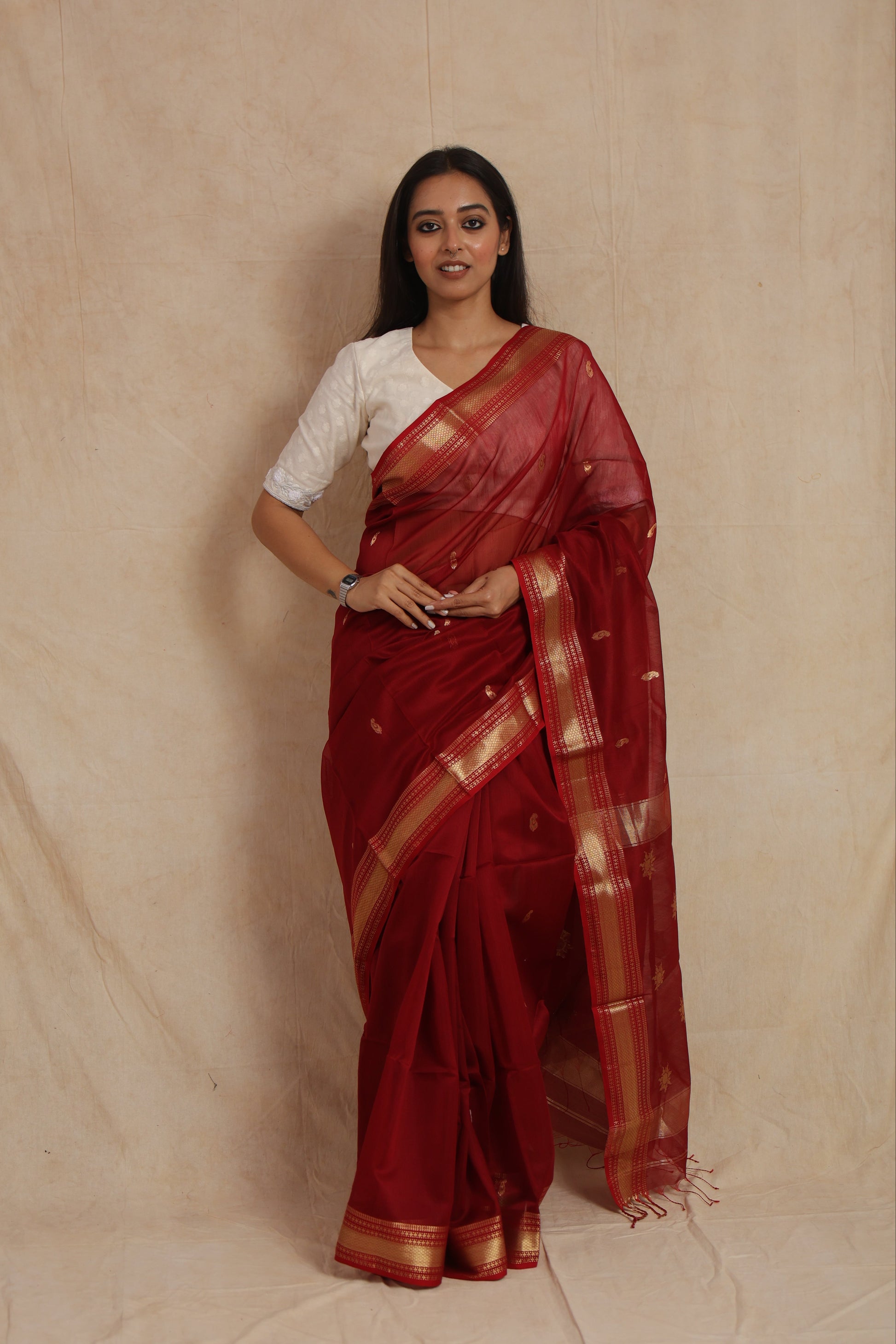 Full drape look of ruby red Maheshwari silk cotton saree with golden woven border