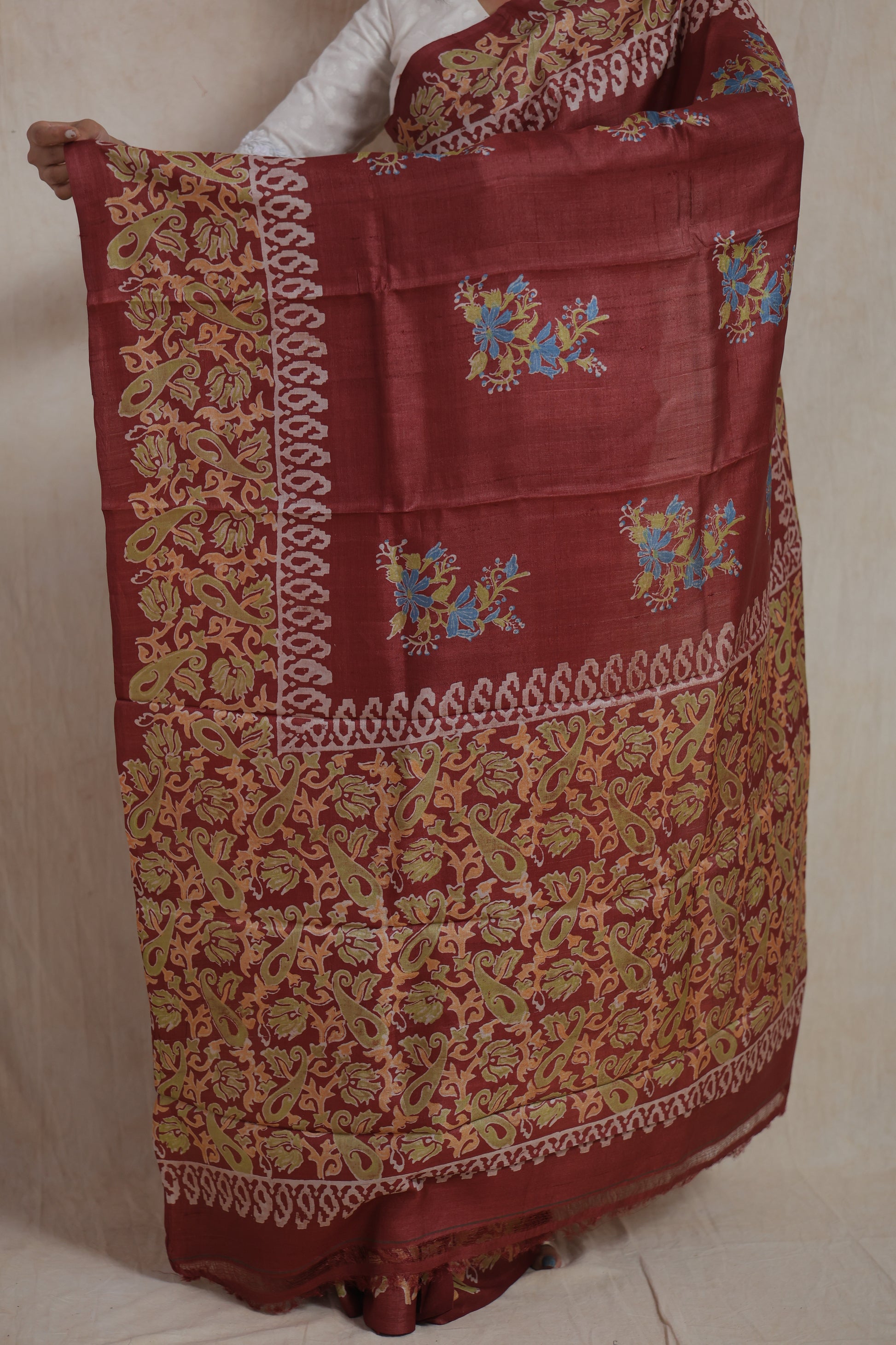 Full pallu view of rust brown Batik silk saree with artistic floral motifs