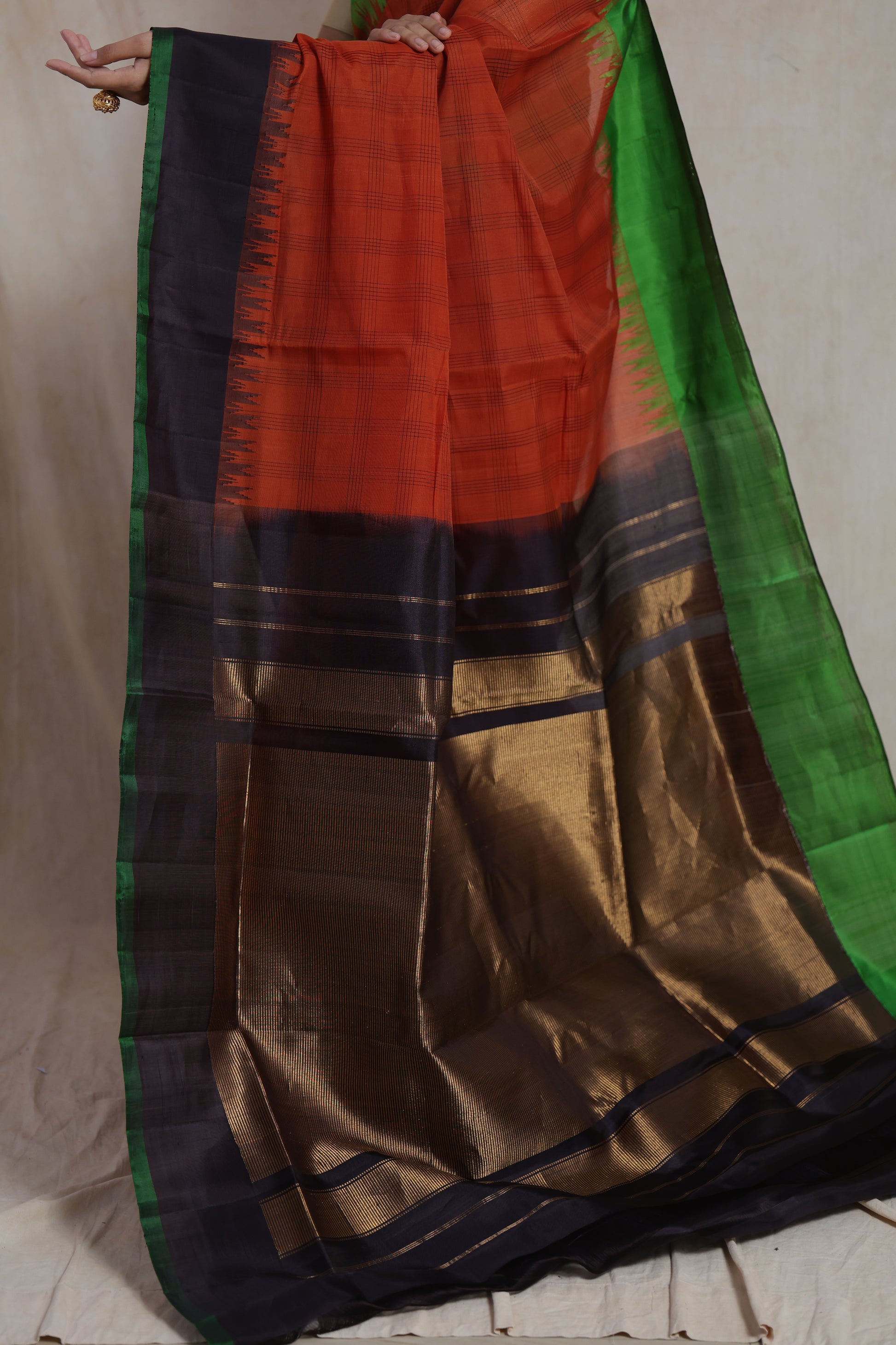 Detailed pallu view of rust orange Gadwal Sico saree with zari woven design