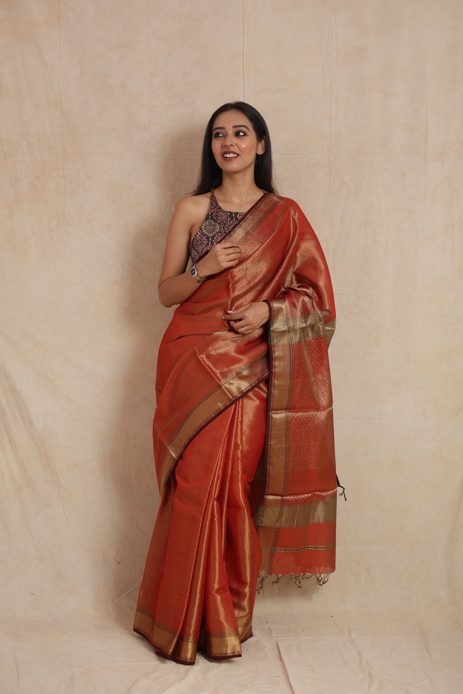 Elegant styling in rust orange Maheshwari tissue saree