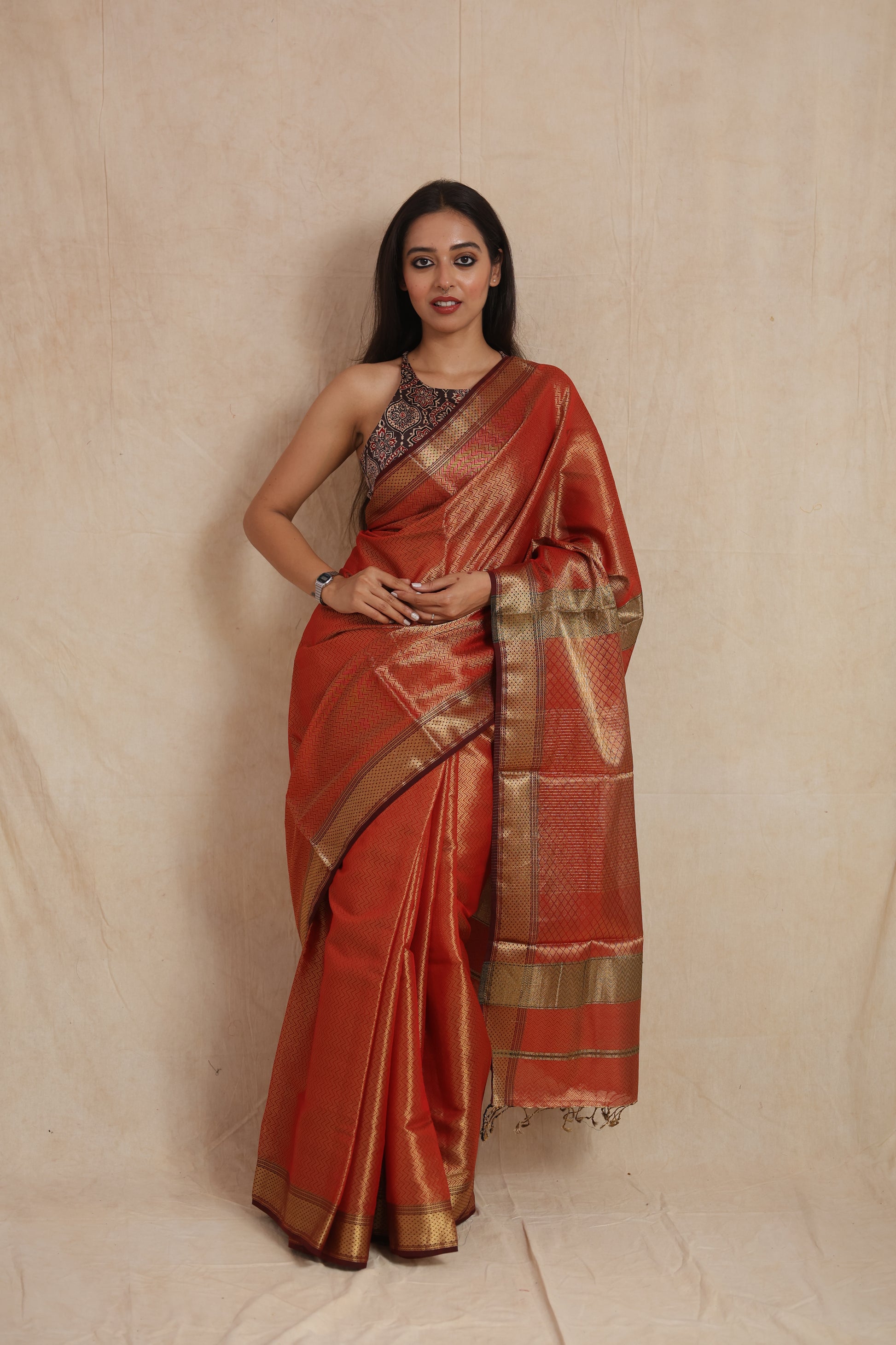 Front view of rust orange Maheshwari tissue saree with zari border