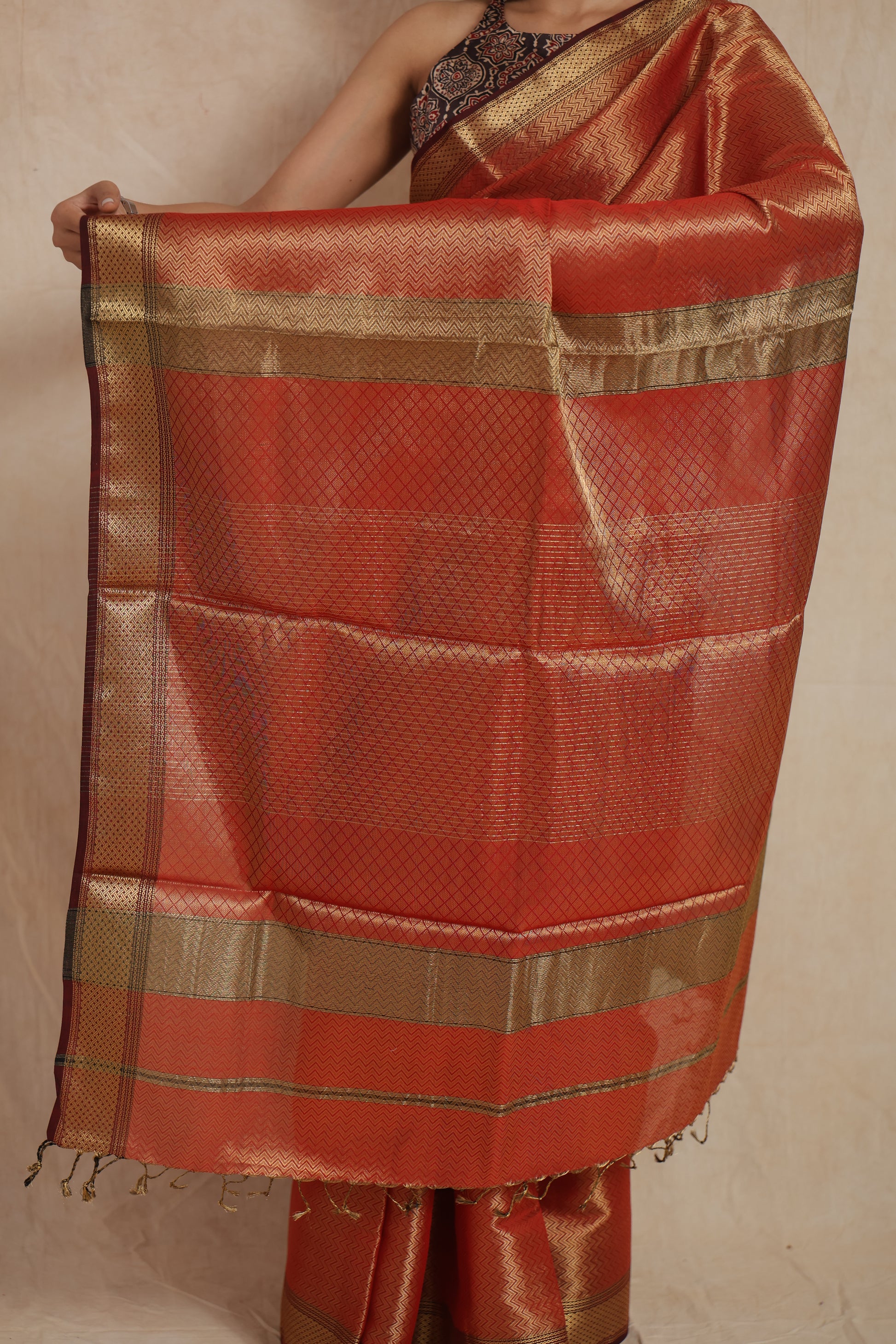 Detailed close-up of zari woven pallu on Maheshwari tissue saree