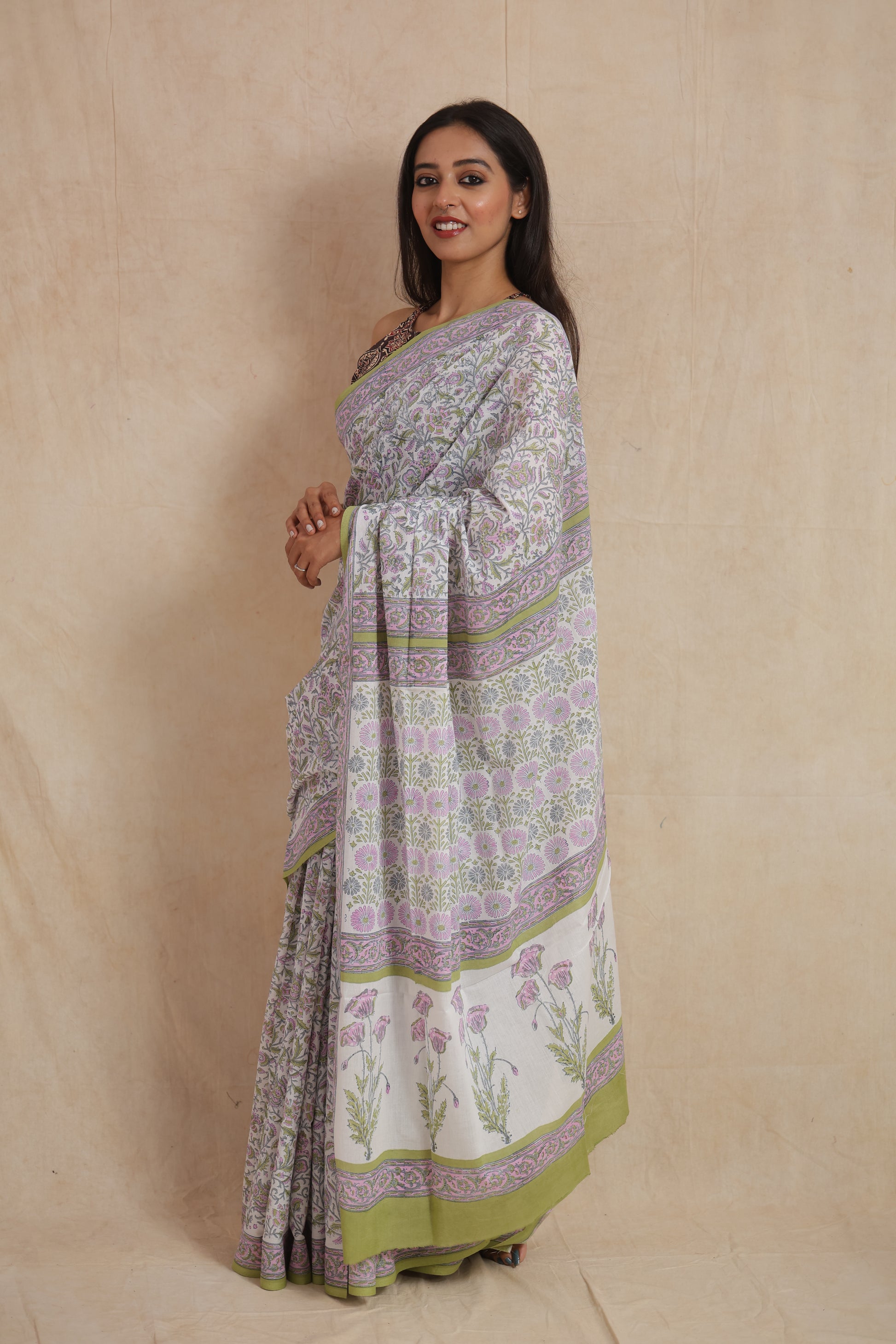 Floral printed pallu detail of pastel Sanganeri cotton saree