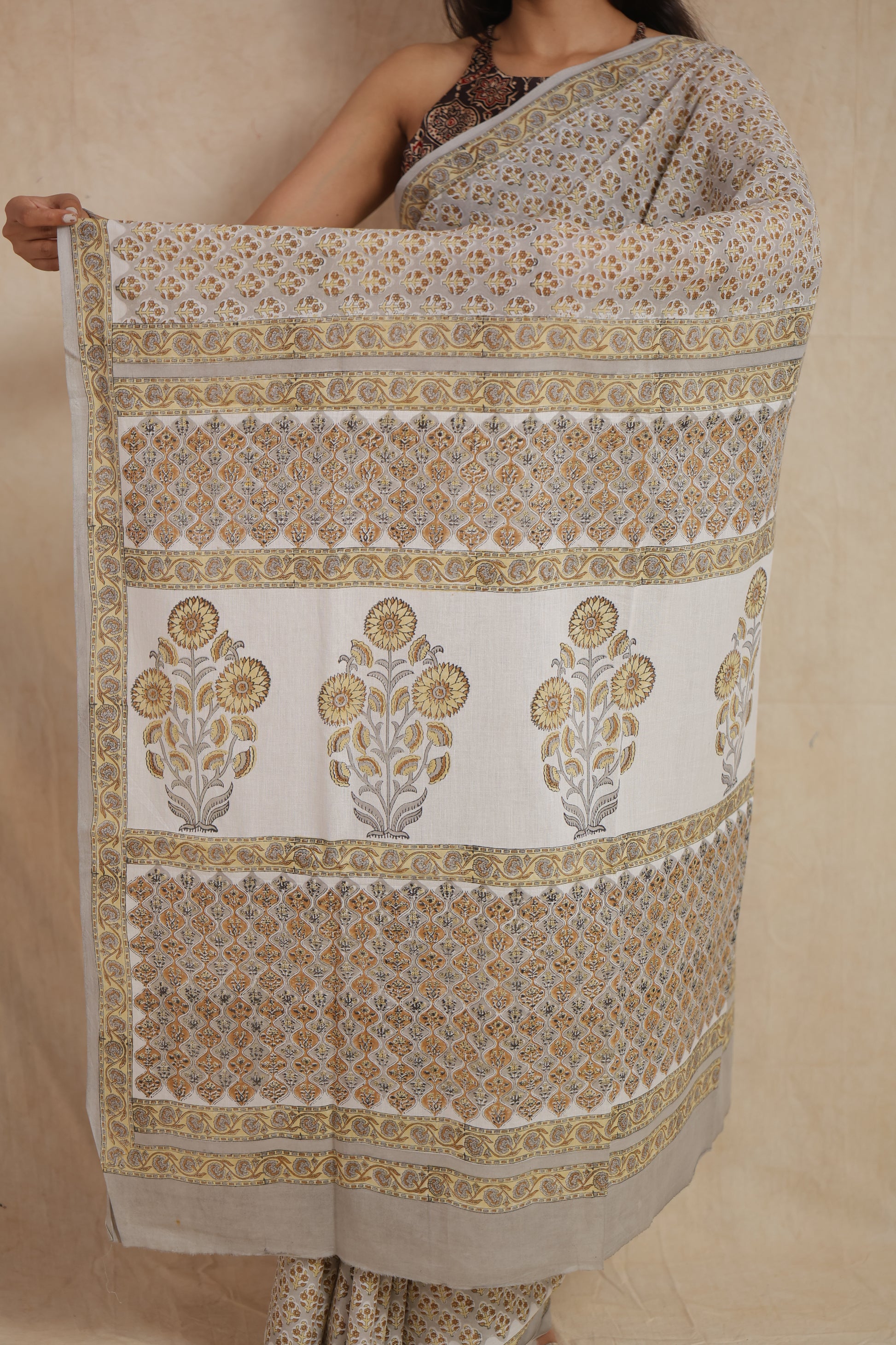 Detailed floral pallu design on beige Sanghaneri cotton saree