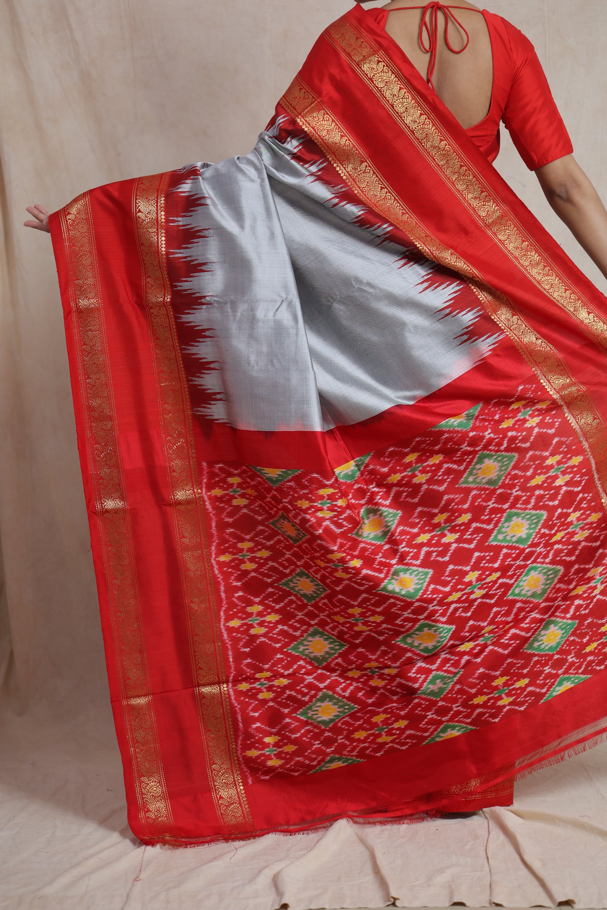 Back drape view of silver grey Panchampali silk saree with red woven pallu