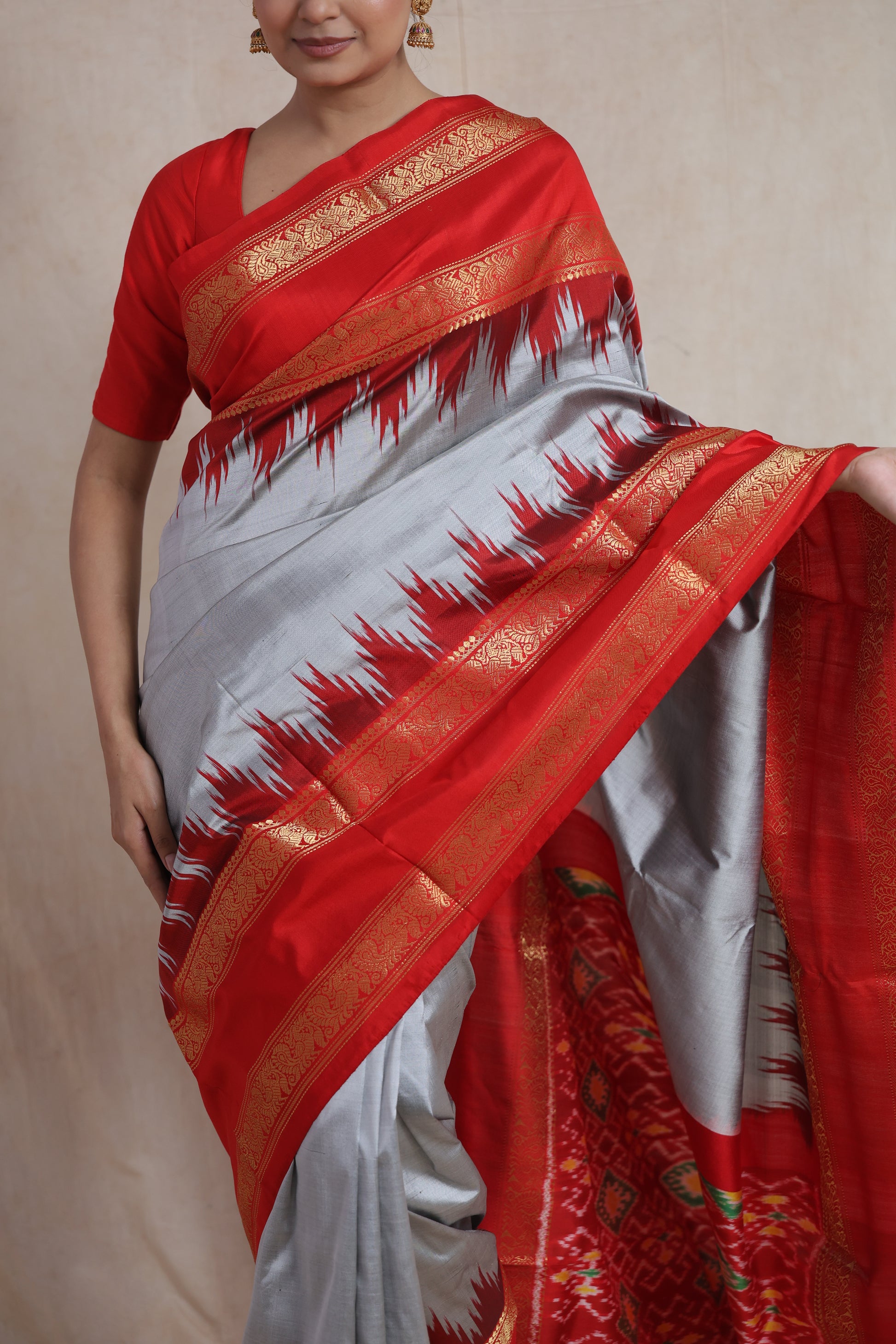 Close-up view of silver grey Panchampali silk saree with red Ikat border