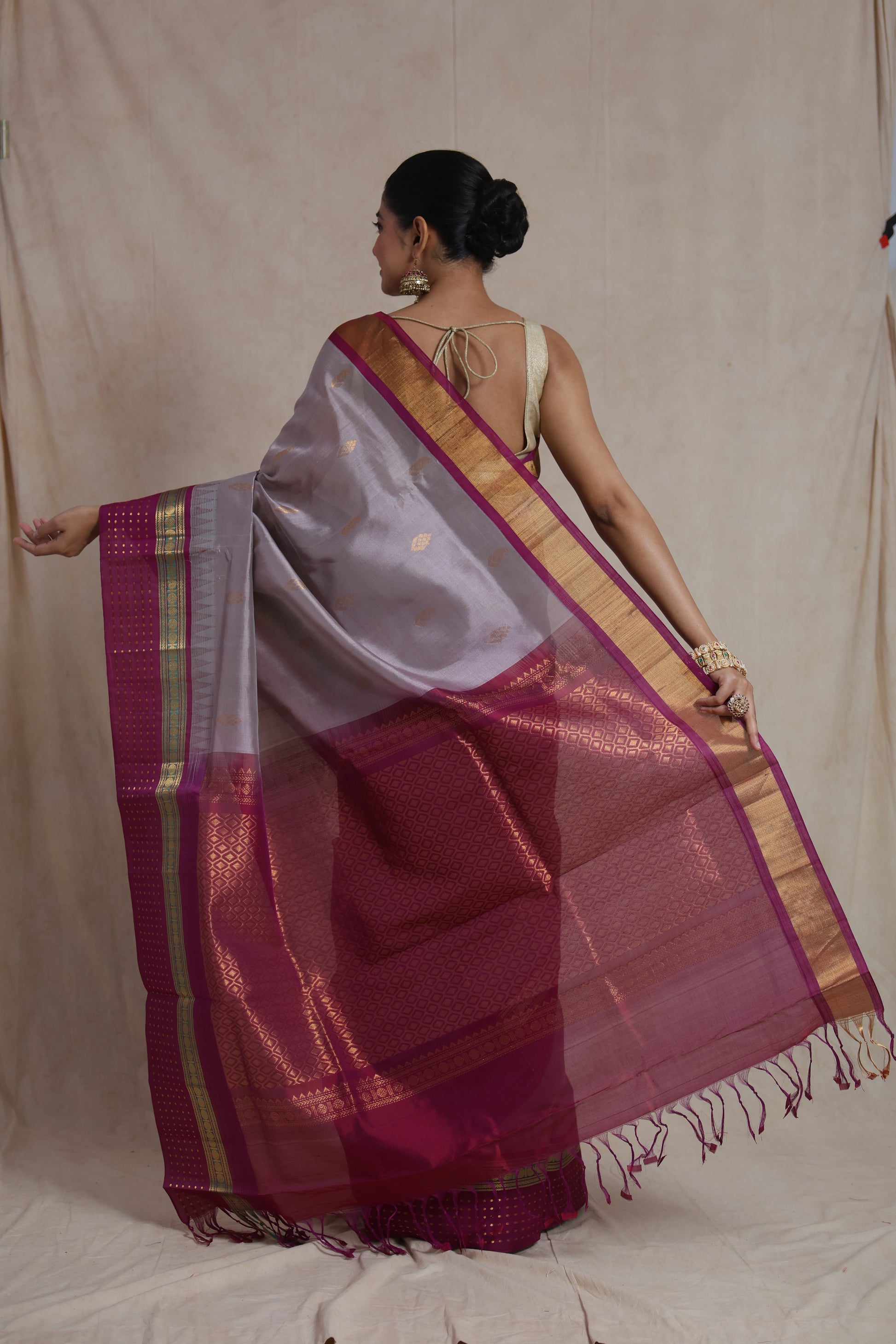 Back drape view of silver grey Kanchipuram handloom Sico saree with magenta pallu