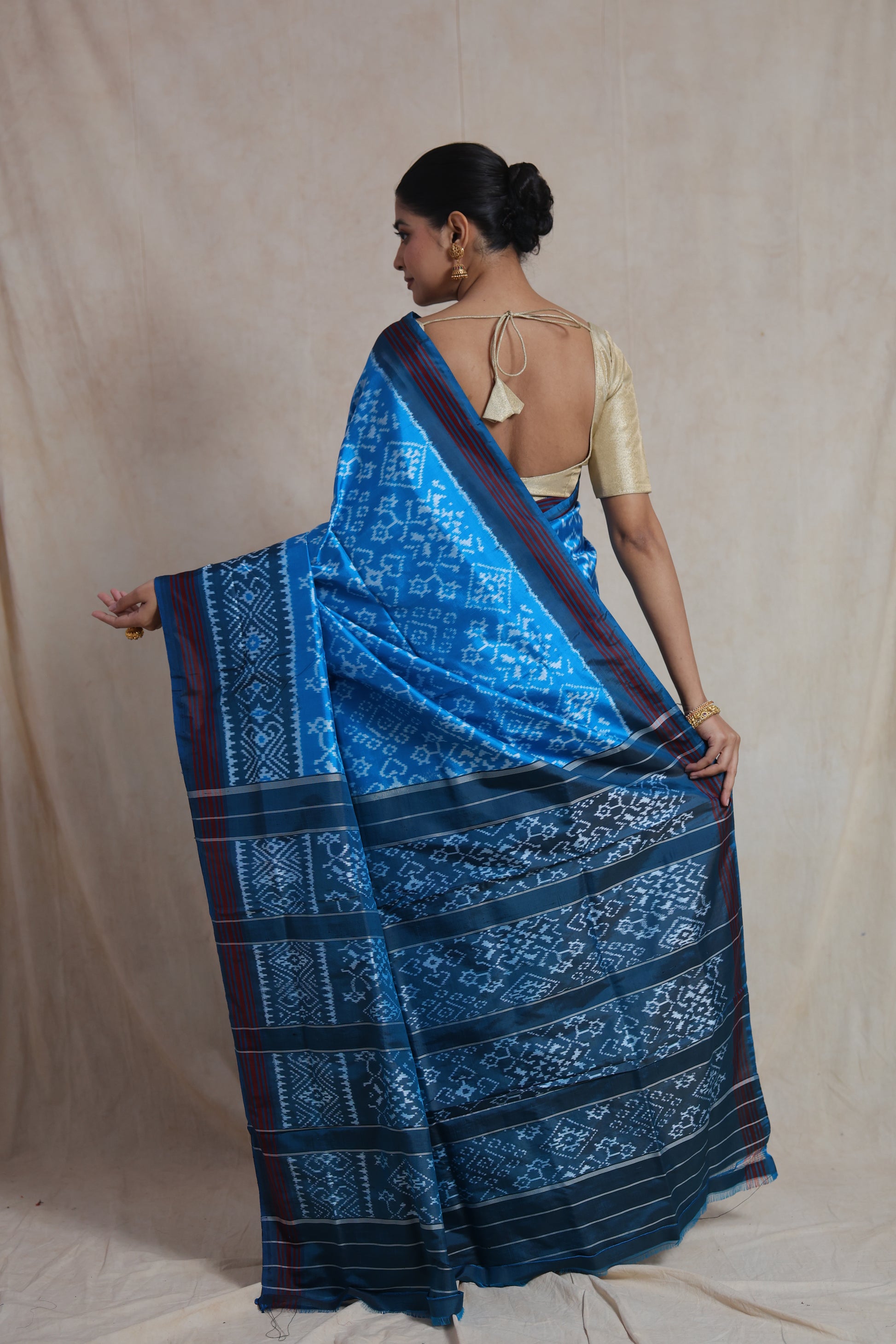 Back drape view of sky blue Panchampali silk saree with traditional Ikat patterns
