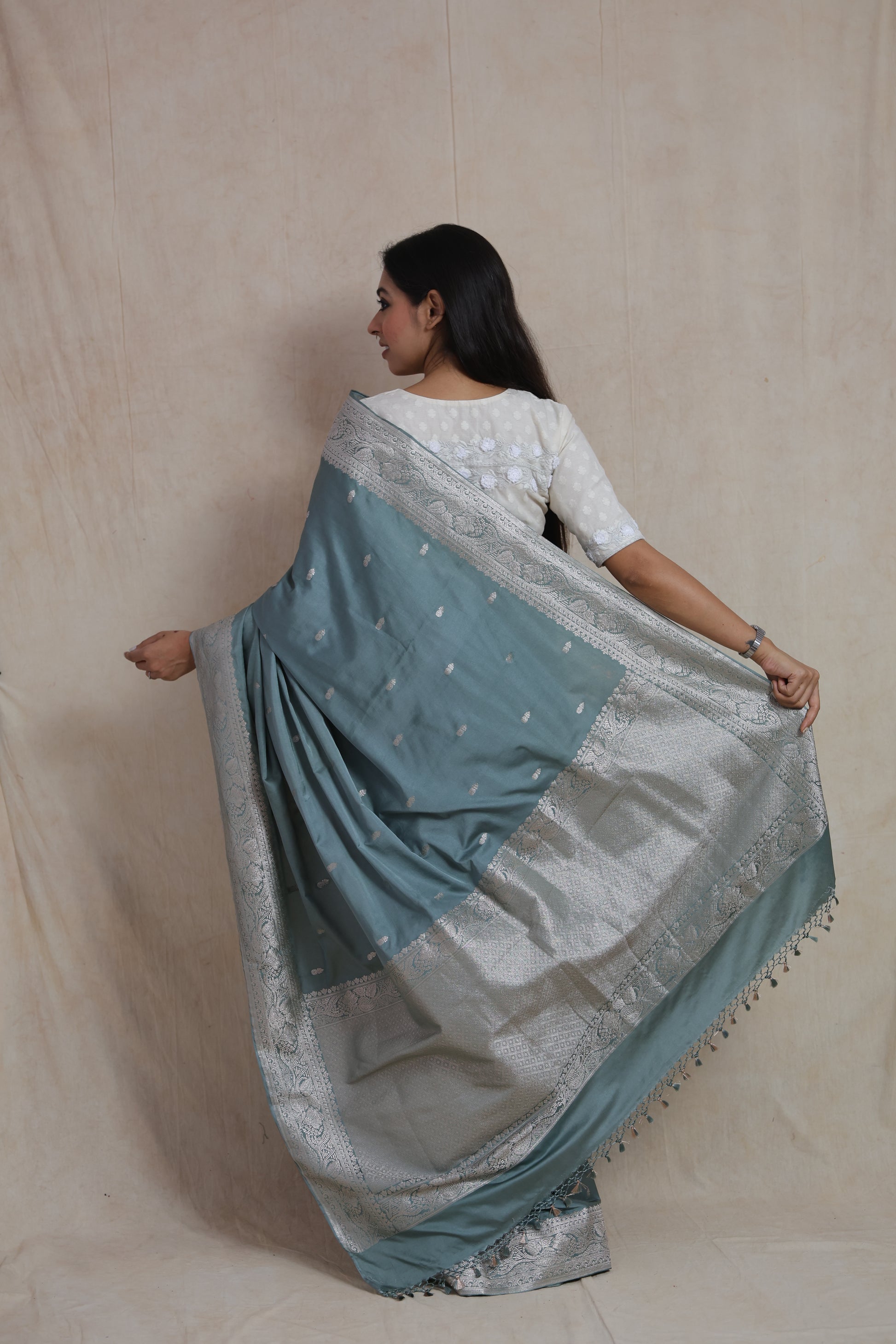 Back pallu view of steel blue Banarasi silk saree with detailed silver zari weaving