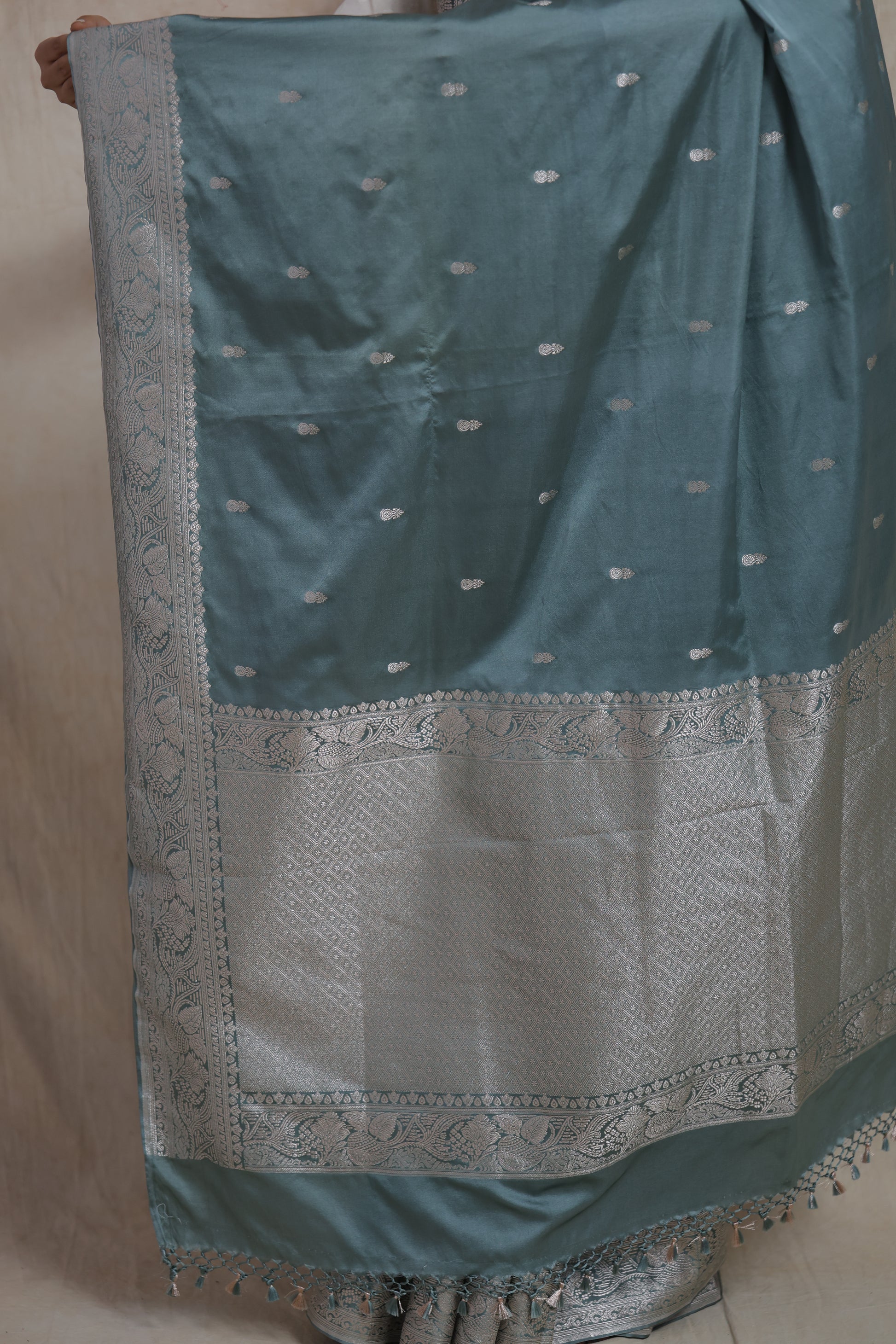 Close-up of silver zari woven pallu on steel blue Banarasi silk saree