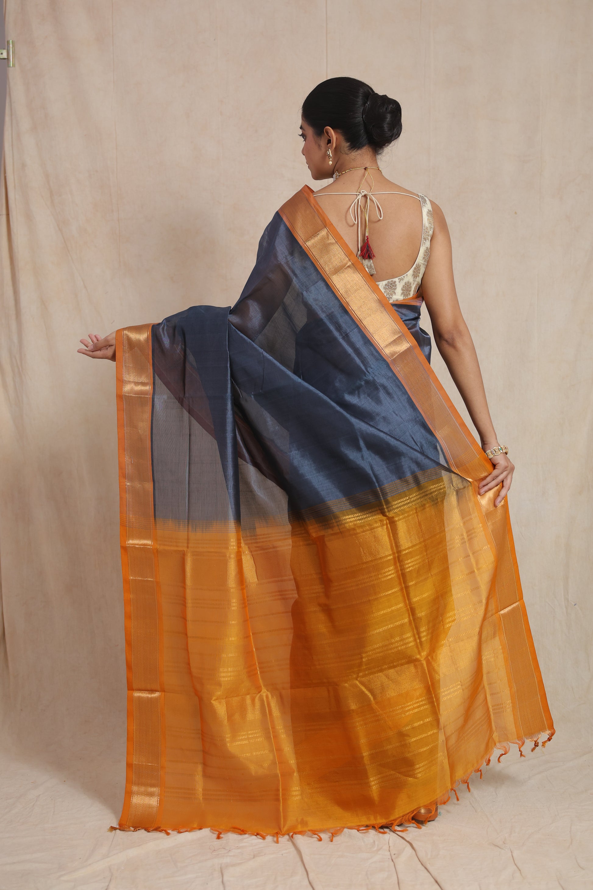 Back view of steel grey Kanchipuram Sico saree with rich mustard gold pallu
