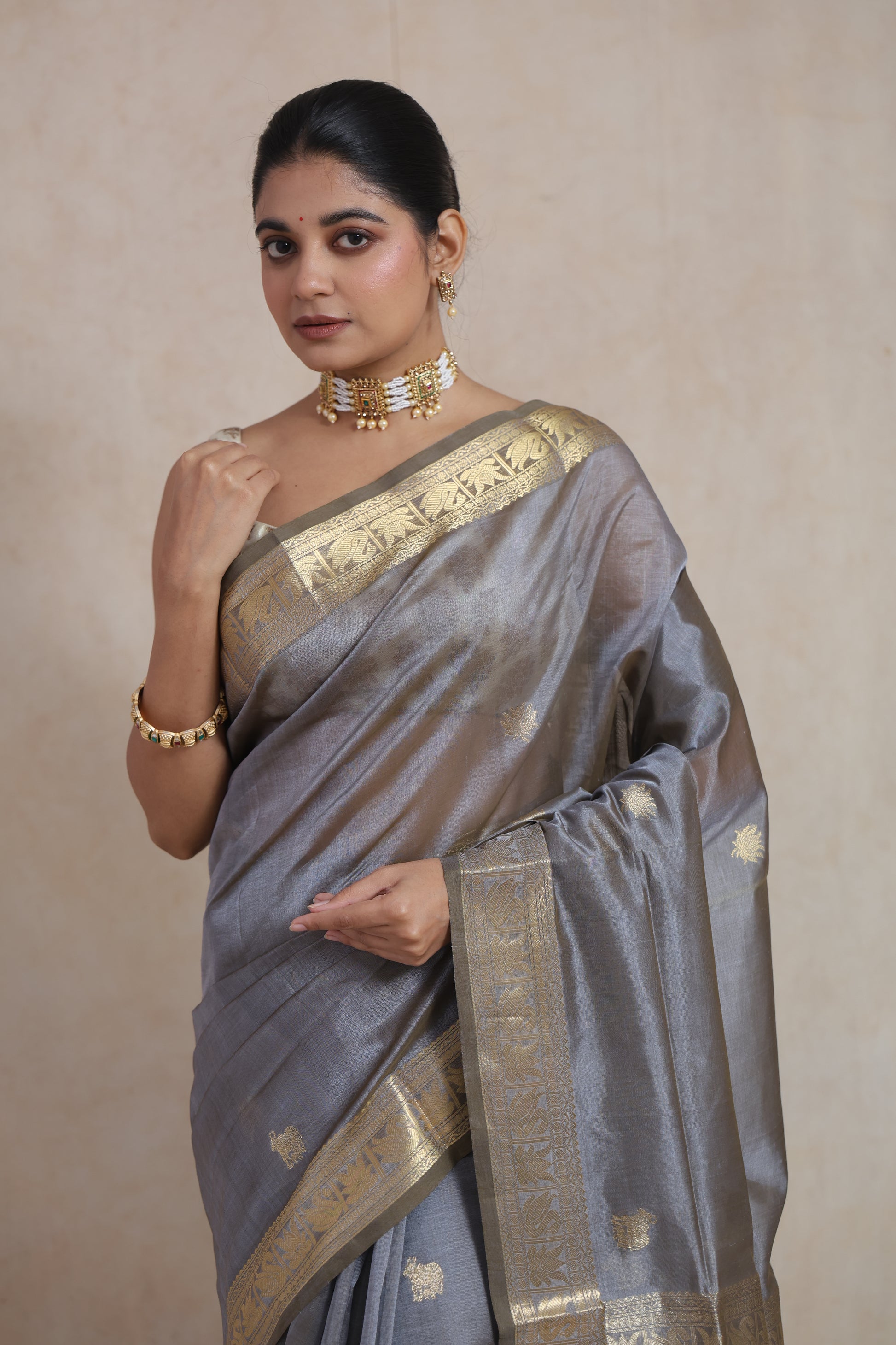 Close-up of antique gold zari border on steel grey Kanchipuram Sico saree