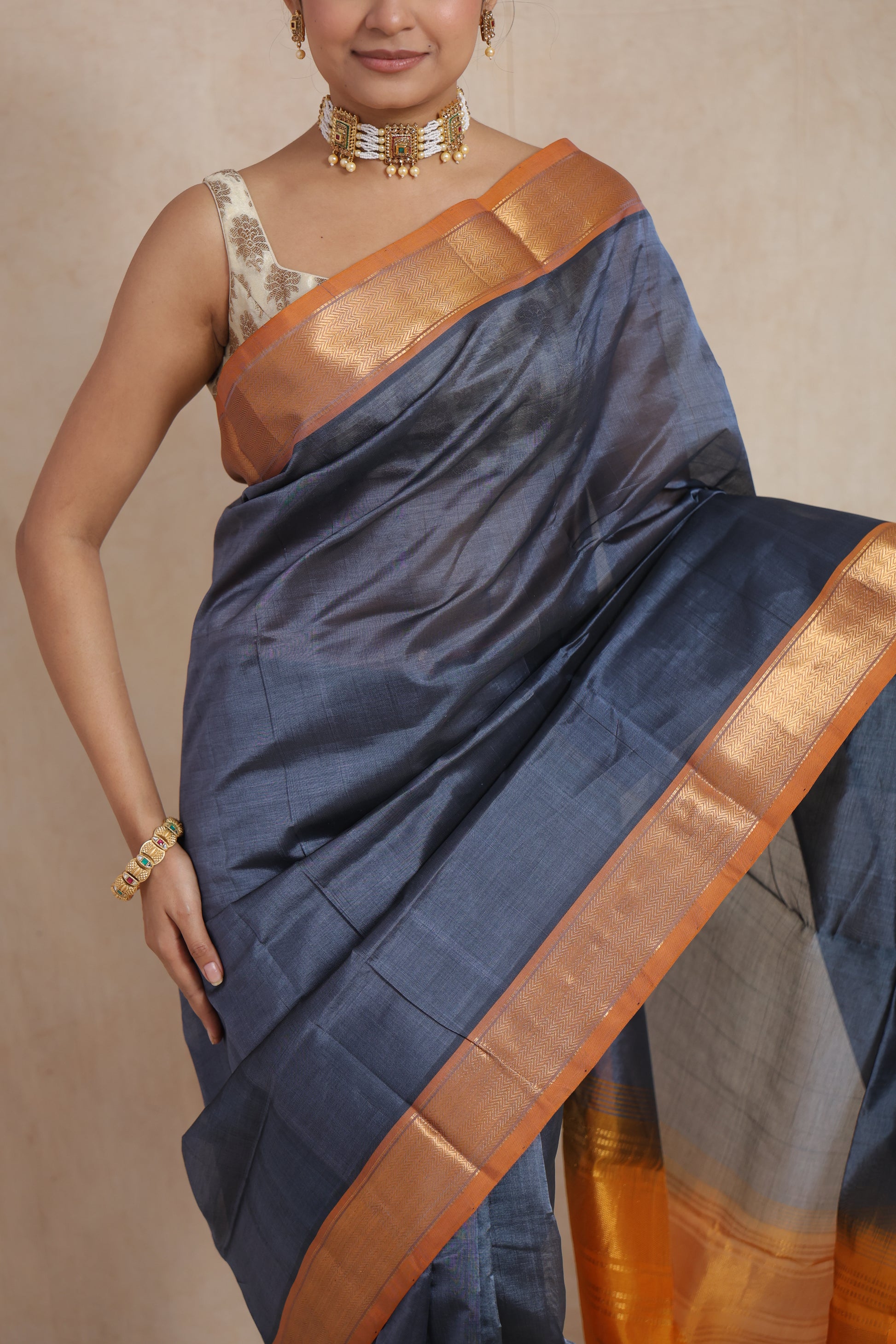 Close-up of steel grey Kanchipuram Sico saree with mustard gold zari border