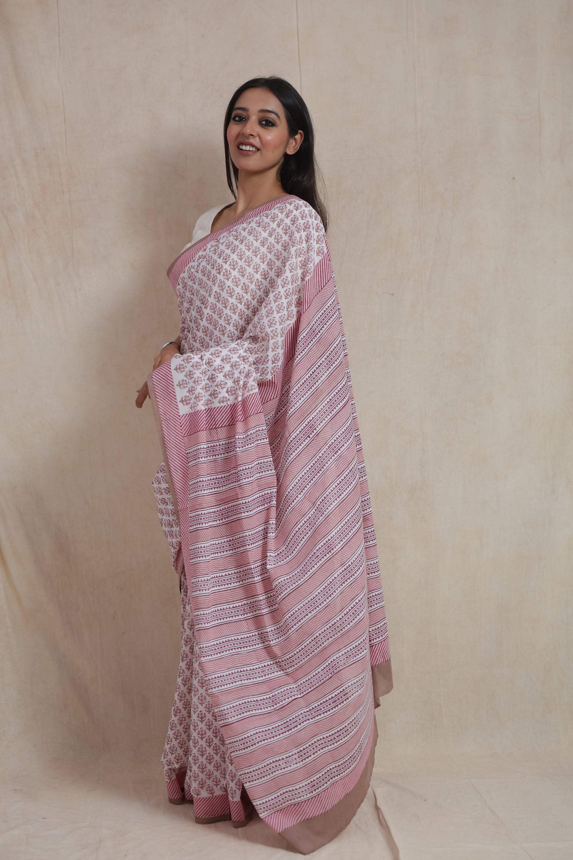Side view of dusty pink Sanghnaree cotton saree with striped pallu