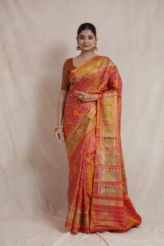 Full-length view of sunset coral Patola handloom silk saree with elegant woven patterns
